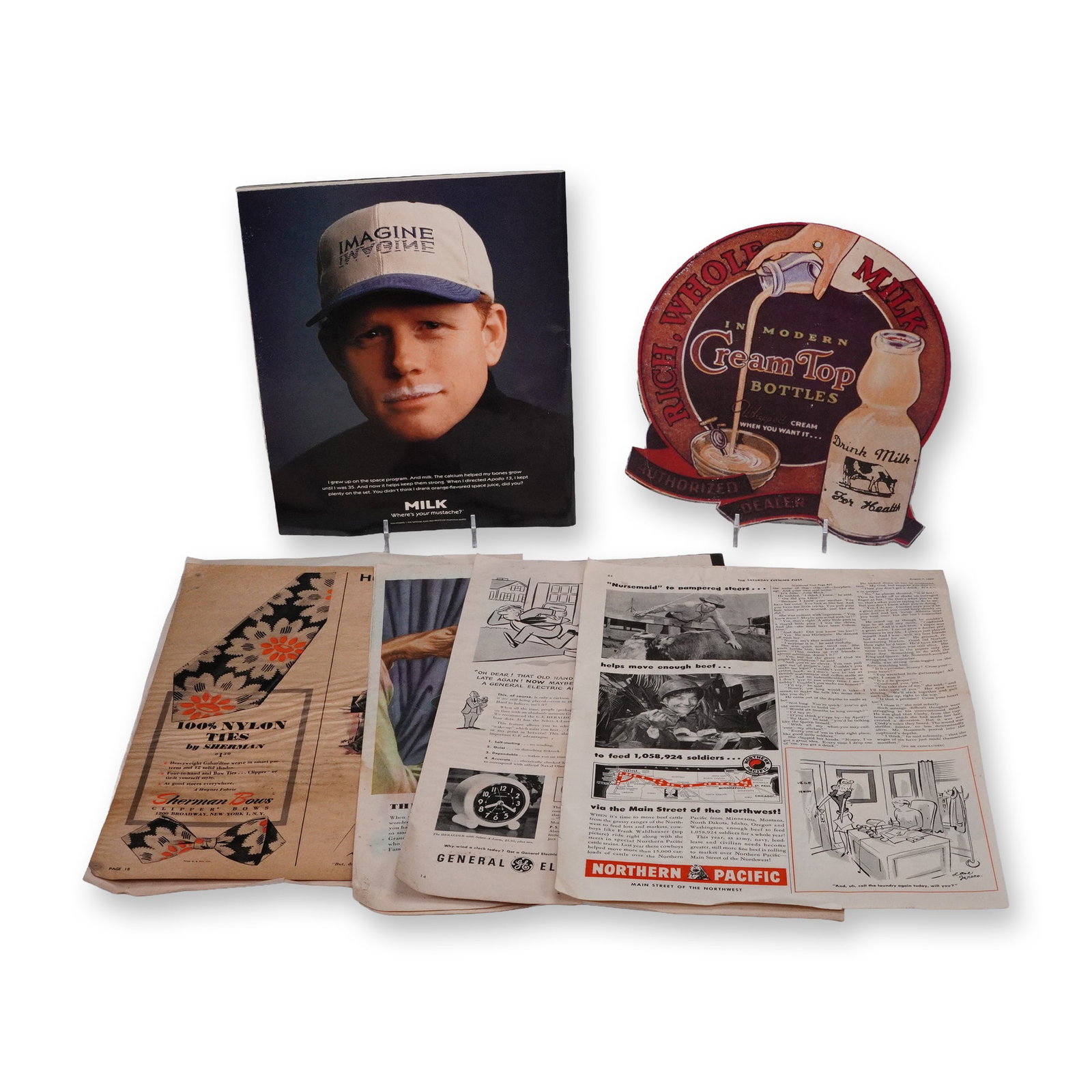 8pc Collection of Vintage Advertising & Magazine Memorabilia, 1940s: Group of early advertising and magazine memorabilia including original 1946 and 1949 magazine pages featuring automotive, travel, and consumer product ads, a vintage die-cut "Cream Top Milk" sign,