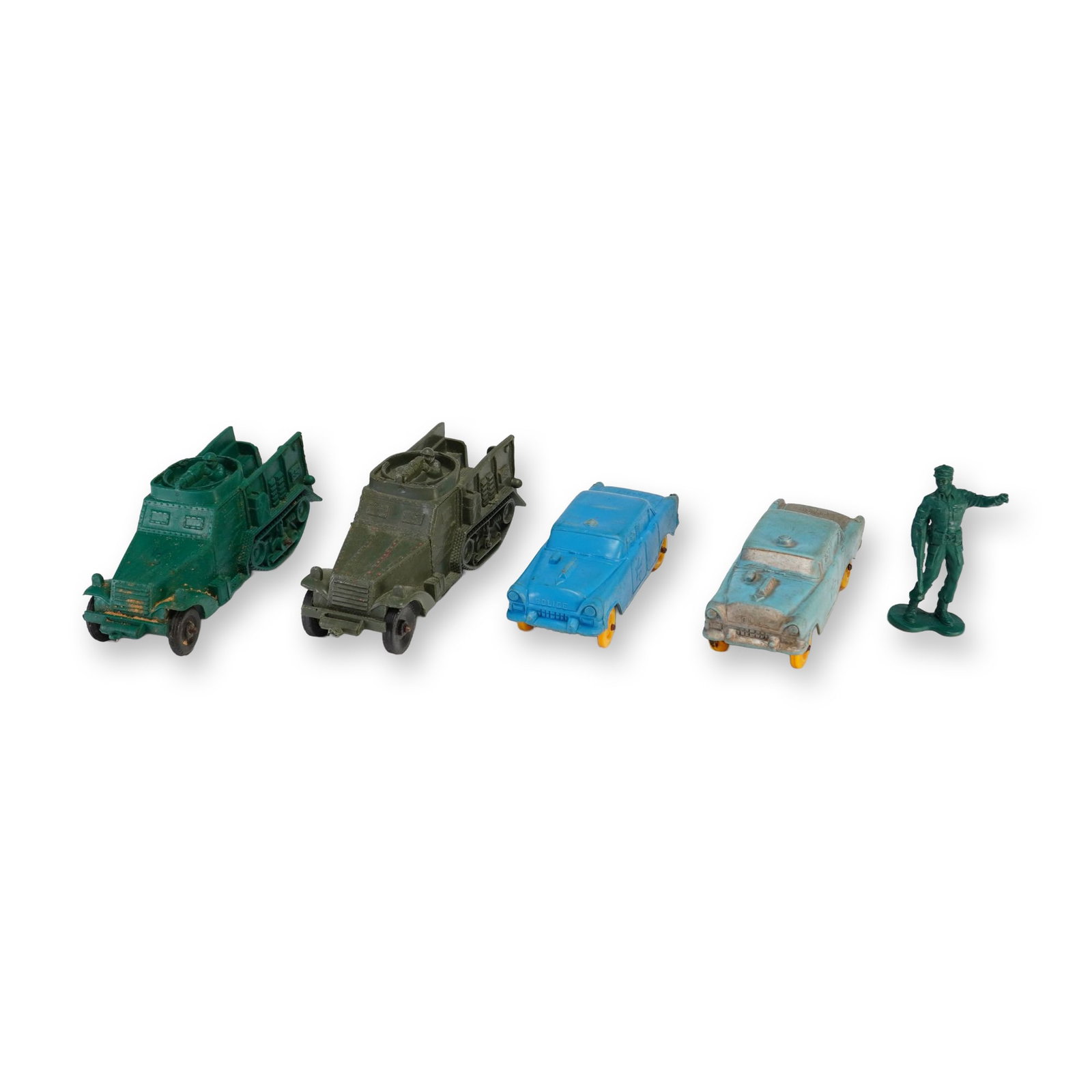 5pc Plastic Toy Army and Police Vehicles with Soldier Figure: This collection consists of vintage molded soft plastic toys, including military vehicles, police cars, and a soldier figure. The group features two military half-track vehicles, one in bright green a