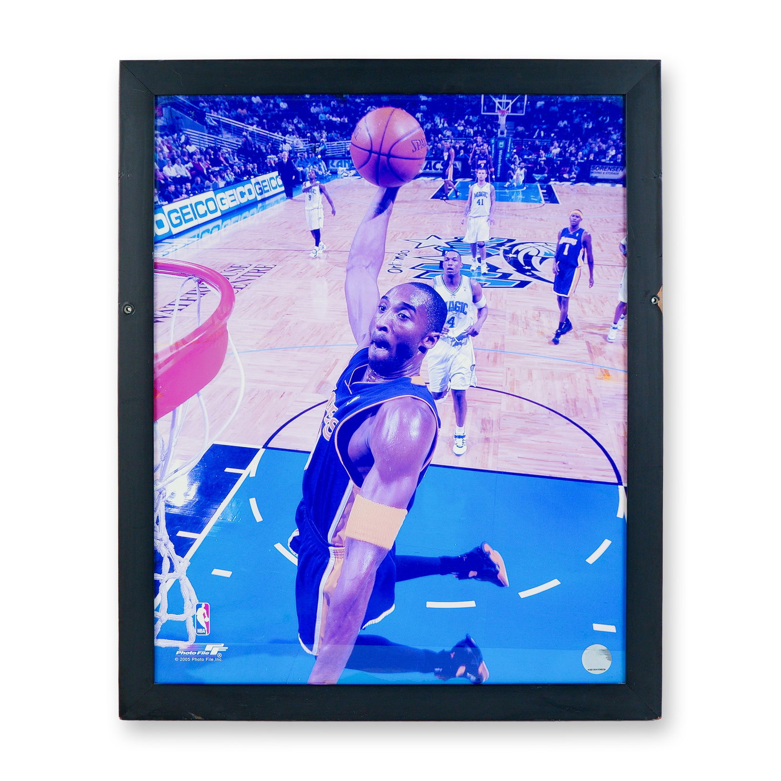 Kobe Bryant Slam Dunk Color Photograph Print w/ NBA Authentication Hologram: An electrifying framed print capturing Kobe Bryant in mid-flight, finishing a thunderous dunk against the Orlando Magic. Kobe Bryant's legacy as one of the greatest to ever play the game makes this a