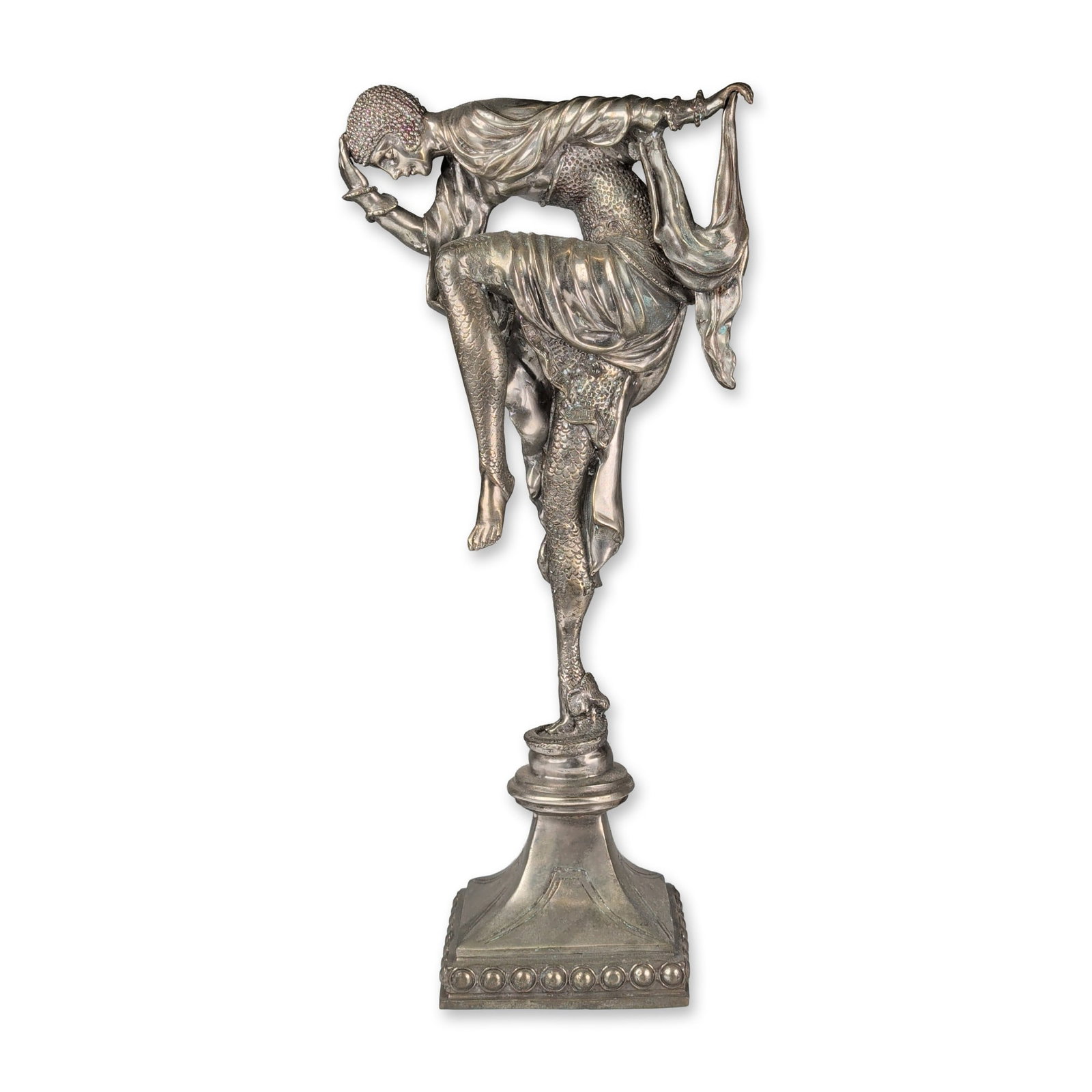After Demetre Chiparus Art Deco Style Patinated Brass Snake Dancer Sculpture: After Demetre Chiparus Art Deco style sculpture depicting a female figure in a dynamic theatrical pose. The figure features textured fish scales on the legs and lower torso, wearing a beaded skullcap 