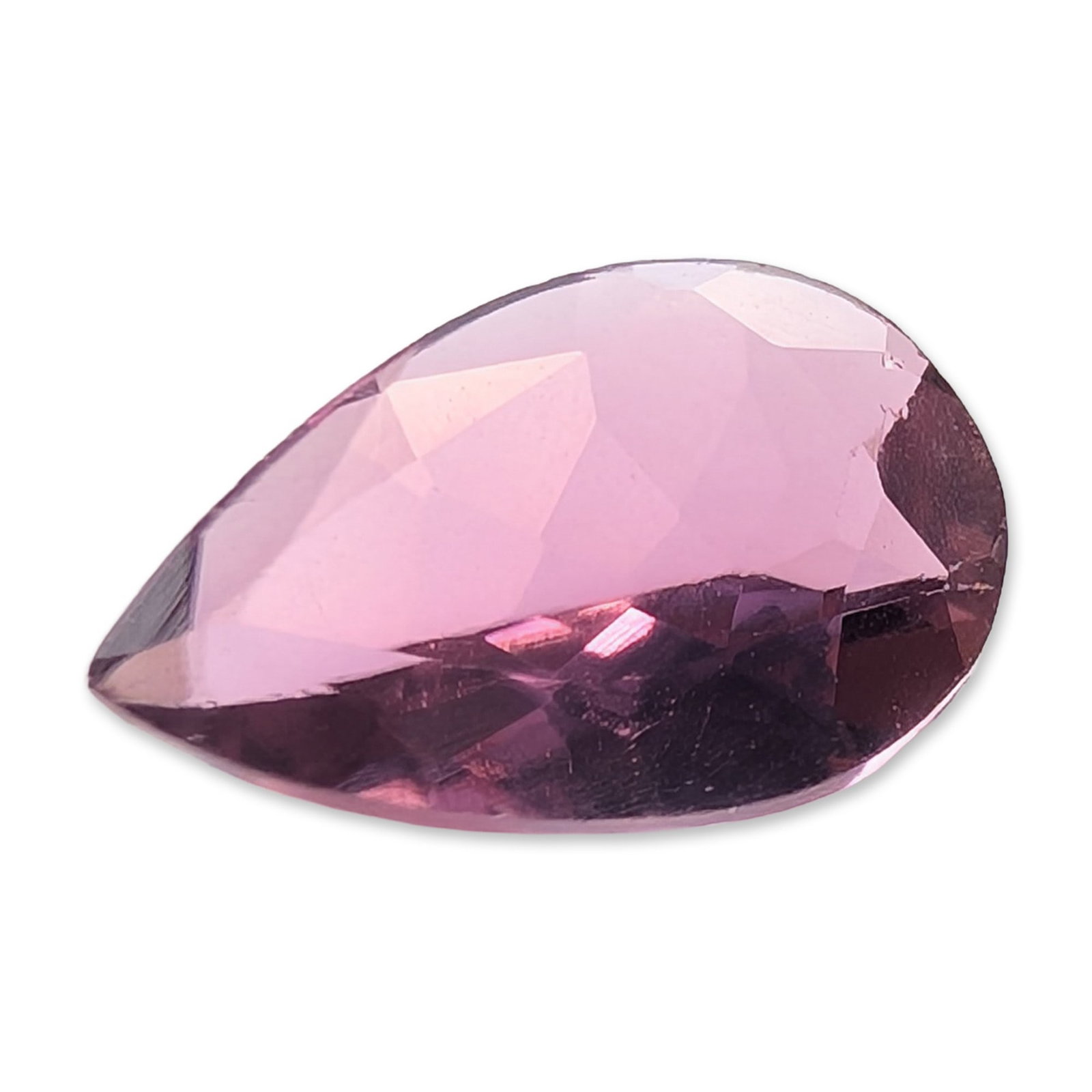 Pear Cut Purplish-Pink Loose Gemstone: Loose faceted gemstone in a pear-shaped brilliant cut, featuring a medium-saturated purplish-pink hue with magenta undertones. The stone exhibits high clarity and appears eye-clean, showing no