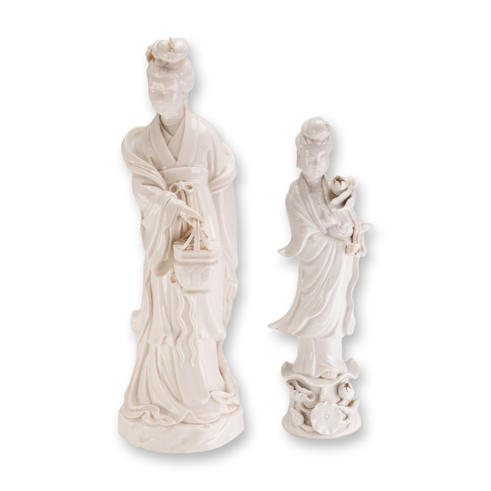 2pc Chinese Blanc de Chine Style Porcelain Women Figurines: This lot of 2 porcelain figurines depicting Oriental women as-is is rendered in the Blanc de Chine style. The taller figurine depicts a standing female figure dressed in traditional flowing robes with