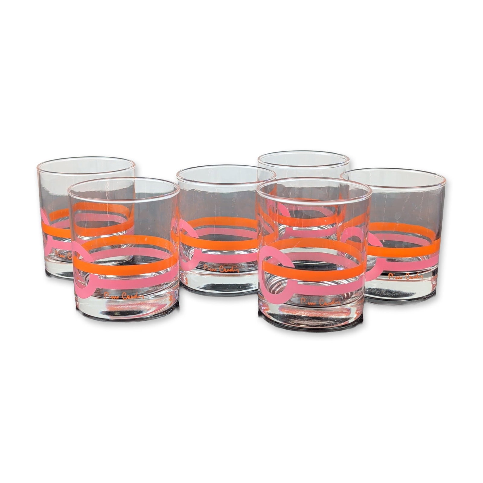 6pc Pierre Cardin Glass Tumblers: Pierre Cardin Mid-Century Modern drinking glasses in clear glass, featuring a Space Age graphic pattern of overlapping circles and ovals in orange, pink, brown, and black enamel. Each tumbler bears