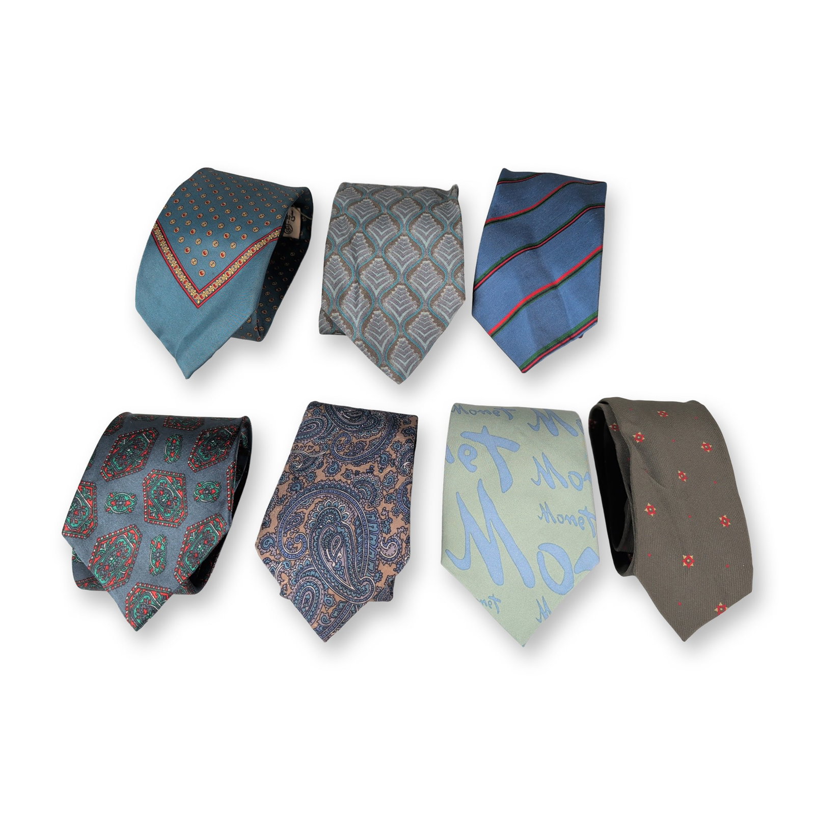 7pc Group of Designer Neckties: Assorted contemporary and vintage designer necktie group. Collection of seven men's ties featuring geometric, paisley, leaf, and script patterns. Includes three Giorgio Armani examples alongside maker