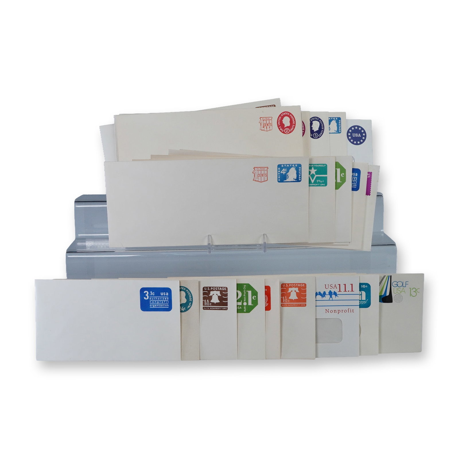 30pc Vintage US Postal Stationery Envelopes: Collection of thirty vintage United States postal stationery envelopes with pre-printed postage in assorted denominations and designs. Includes colorful examples featuring motifs such as the Liberty B