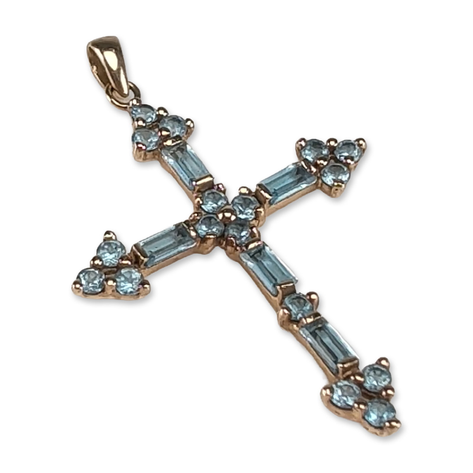 10K Yellow Gold and Blue Topaz Cross Pendant: A 10 karat yellow gold religious pendant in a botonee cross design, set with light blue topazes. The piece features five baguette cut stones, with seventeen round faceted stones arranged in a cluster 