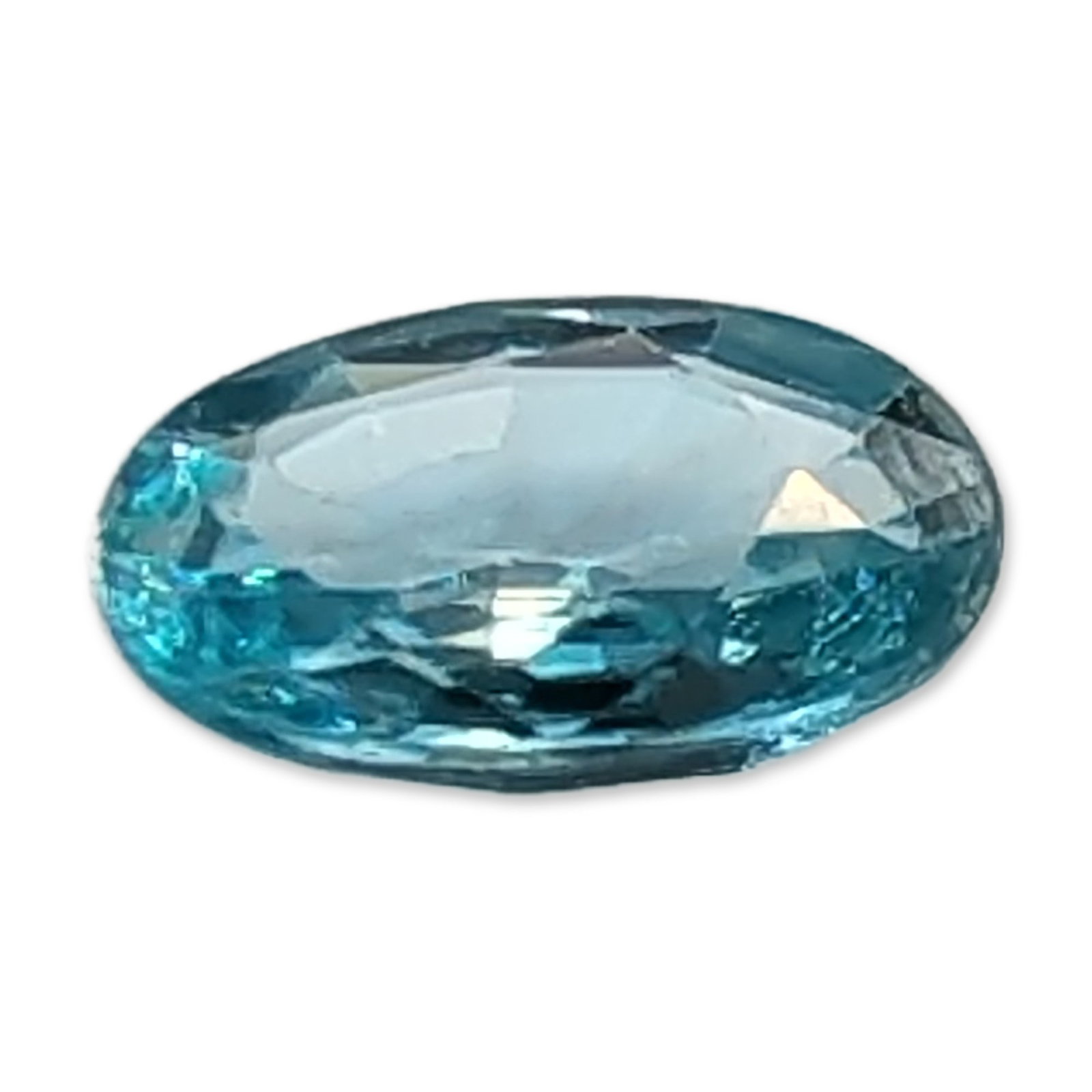 Neon Blue-Green Oval Cut Topaz Gemstone: Oval cut topaz gemstone in a saturated neon blue-green hue. The stone features an oval modified brilliant cut with a faceted pavilion and crown. Transparency is high, with internal characteristics inc