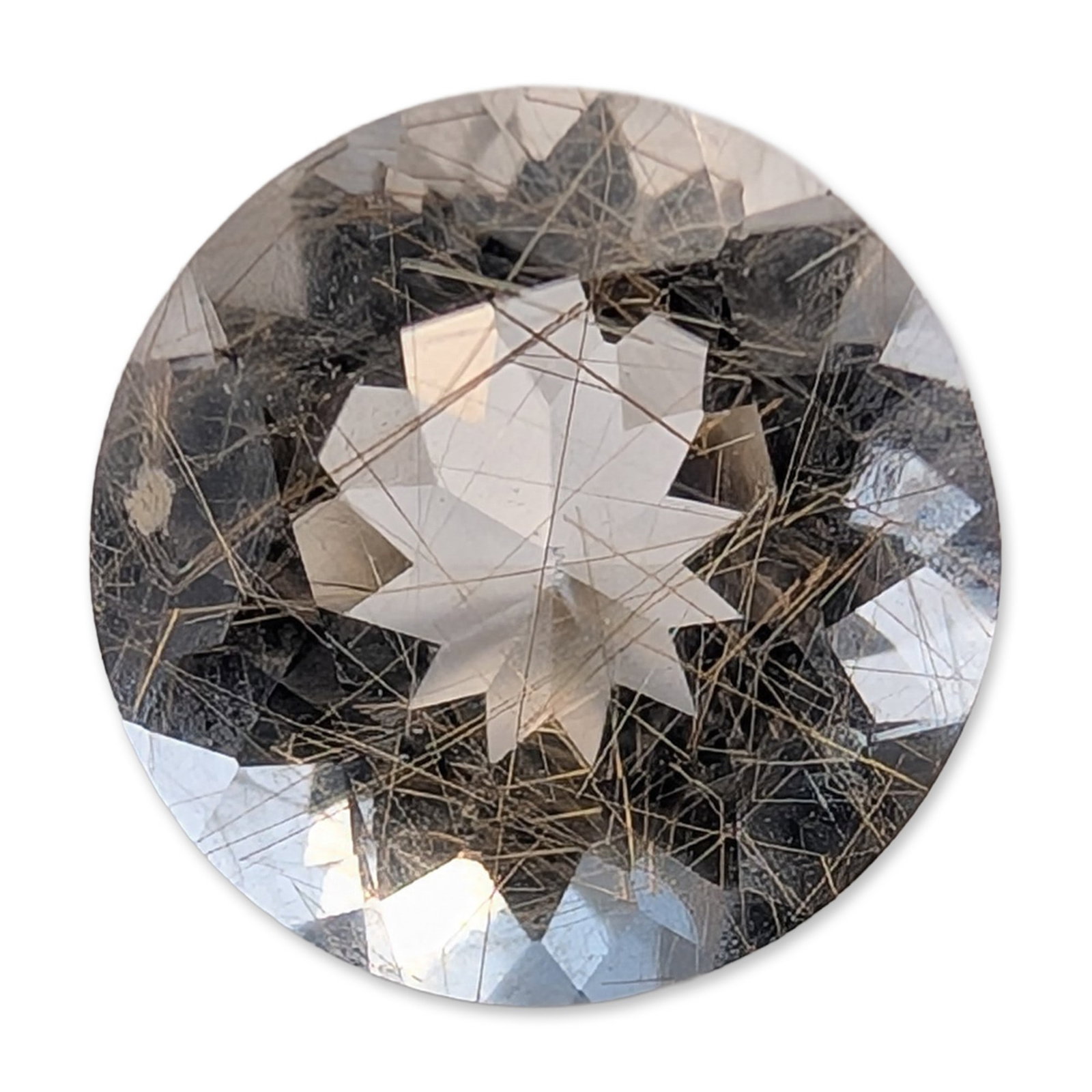 Round Brilliant Cut Rutilated Quartz Gemstone: Round brilliant-cut gemstone that appears to be rutilated quartz. The colorless, transparent host material contains fine, acicular inclusions of golden-brown rutile needles distributed throughout the