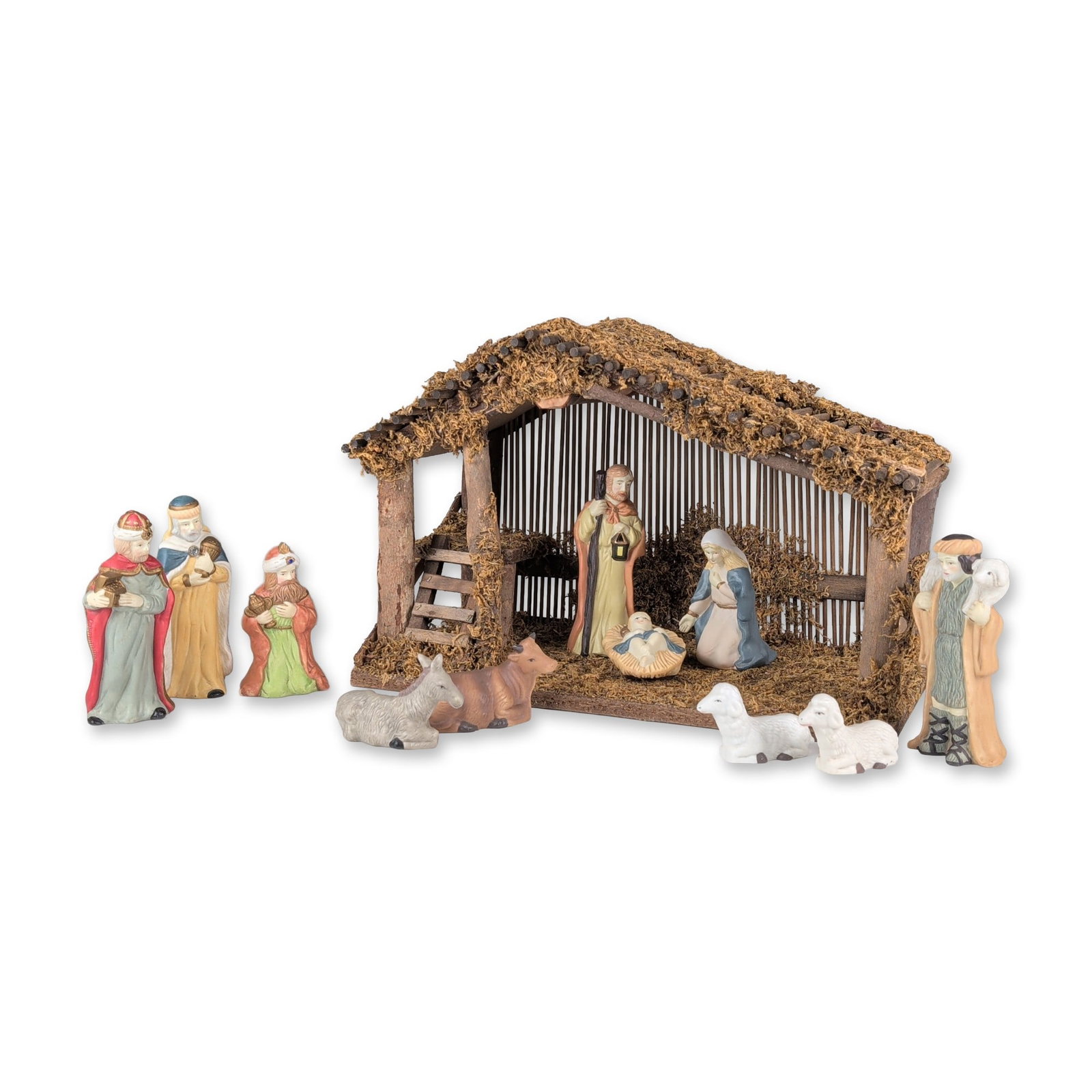12pc Sears Handpainted Porcelain Nativity Figurine Set with Creche: Nativity set in handpainted porcelain, featuring eleven figurines and a rustic wooden creche. The collection includes the Holy Family with Mary kneeling, Joseph holding a lantern and Baby Jesus in a