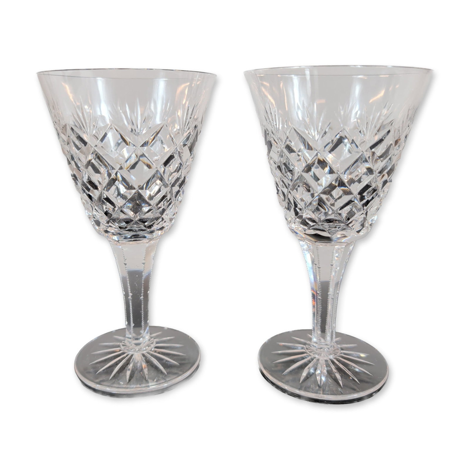 Pair of Cut Crystal Wine Glasses: Pair of cut crystal wine glasses. Each stem features a tulip-shaped bowl with a flared, polished rim, decorated with a lower band of deep criss-cross diamond cuts beneath a row of vertical wedge
