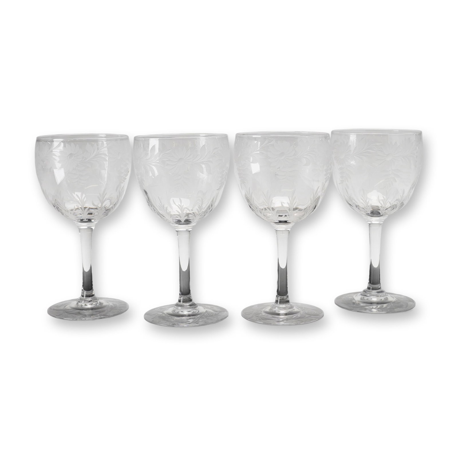 Set of Four Libbey Crystal Stemmed Goblets, Daisy Pattern: This set of stemmed goblets was manufactured by the Libbey Glass Company. Each piece is crafted from clear lead crystal and features the wheel-cut Daisy pattern. The decorative motif consists of a