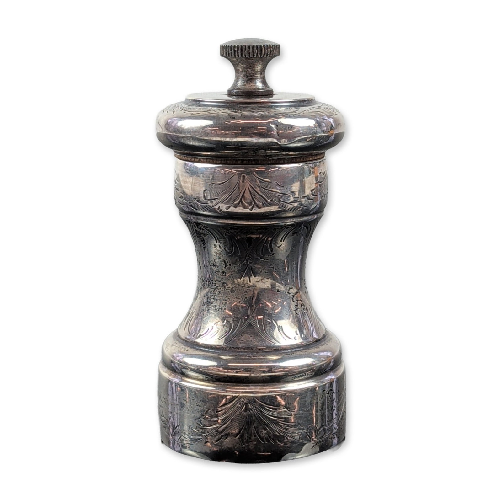 Victorian Style Engraved Sterling Silver Pepper Grinder: This Victorian-style pepper grinder has a baluster shape with hand-chased foliate and floral engravings covering its waisted body and domed cap. It's topped with a knurled metal adjustment finial,
