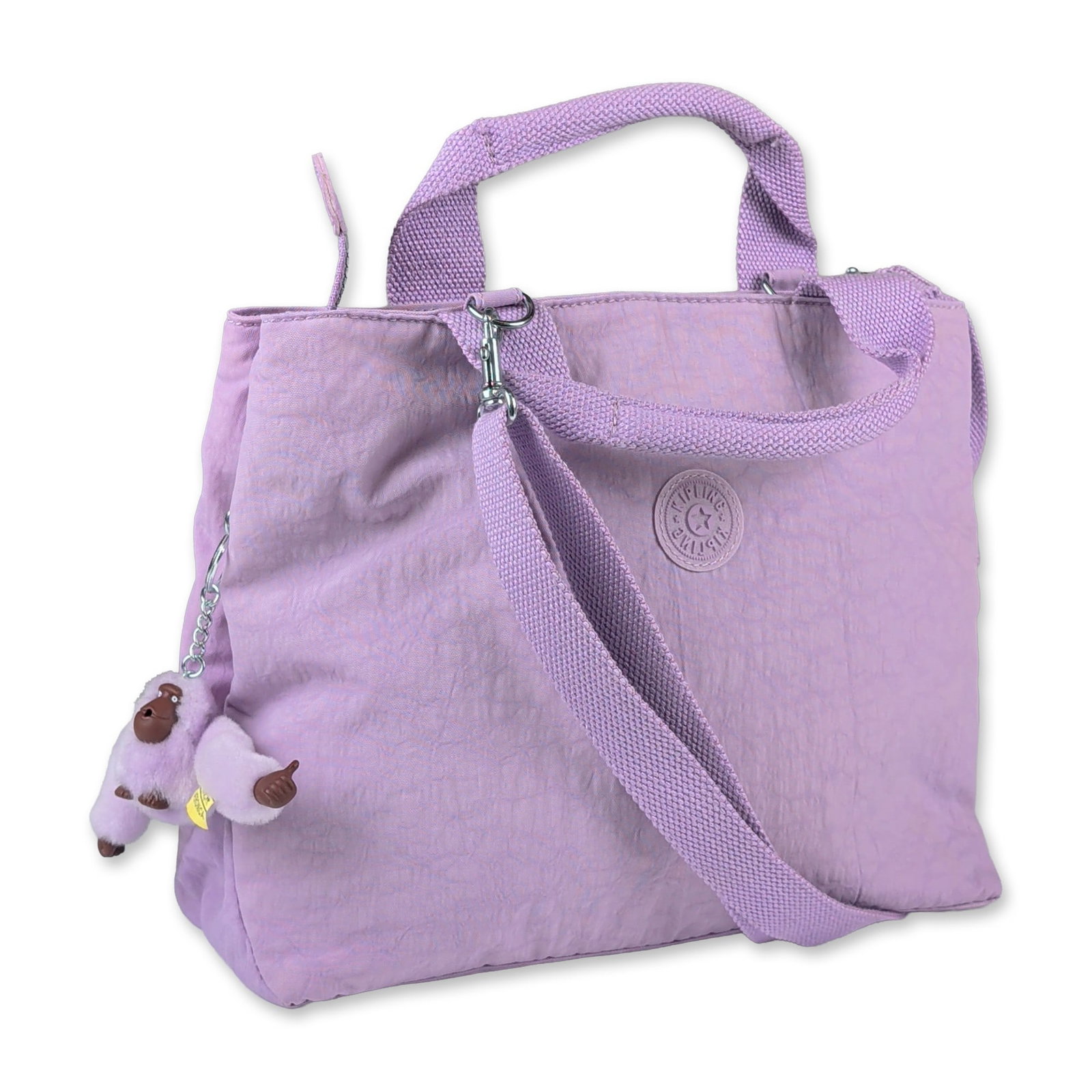 Kipling Lavender Crinkled Nylon Multiway Handbag: Kipling medium multiway handbag in lavender crinkled nylon fabric. The bag features dual fixed top carry handles and a detachable, adjustable woven shoulder strap in a matching tonal color. The exteri