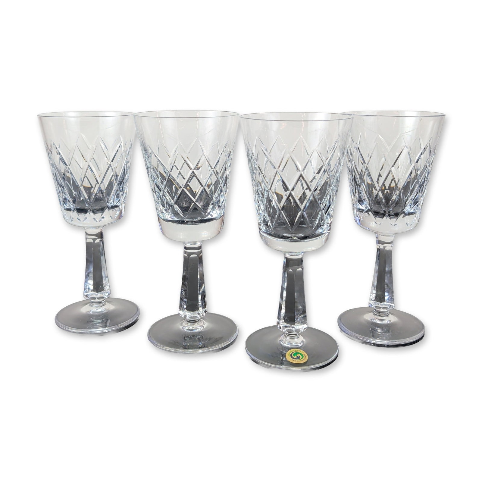 4pc Clontarf Crystal Irish Hand-Cut Stemmed Goblets: Set of four Irish hand-cut crystal stemmed goblets by Clontarf Crystal. The bowls feature a deep-cut diamond lattice pattern surmounted by vertical wedge cuts. Each piece is supported by a