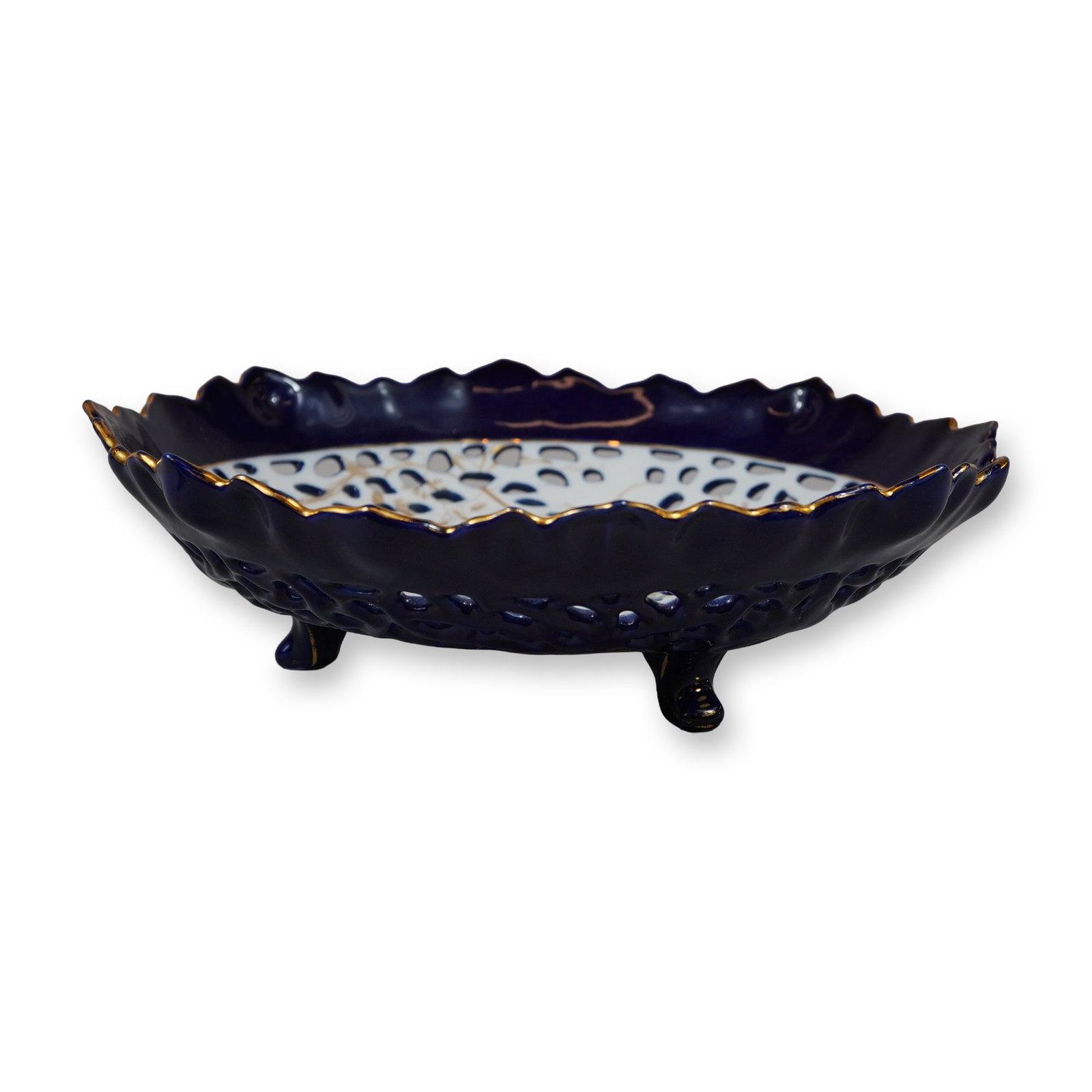 Gien Faience Vented Candy Dish with Blue White and Floral Accents: This shallow circular candy dish is attributed to the French manufacturer Gien and features a vented or reticulated design with blue, white, and floral accents. The piece is constructed with intricate