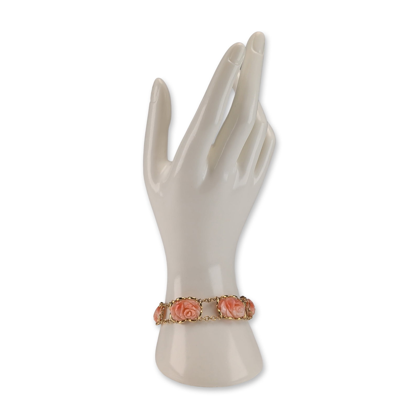 14K Yellow Gold and Carved Coral Rose Link Bracelet: Vintage link bracelet in 14 karat yellow gold featuring six carved coral roses. The coral displays a salmon to light pink color with characteristic natural white banding visible on the reverse of the 