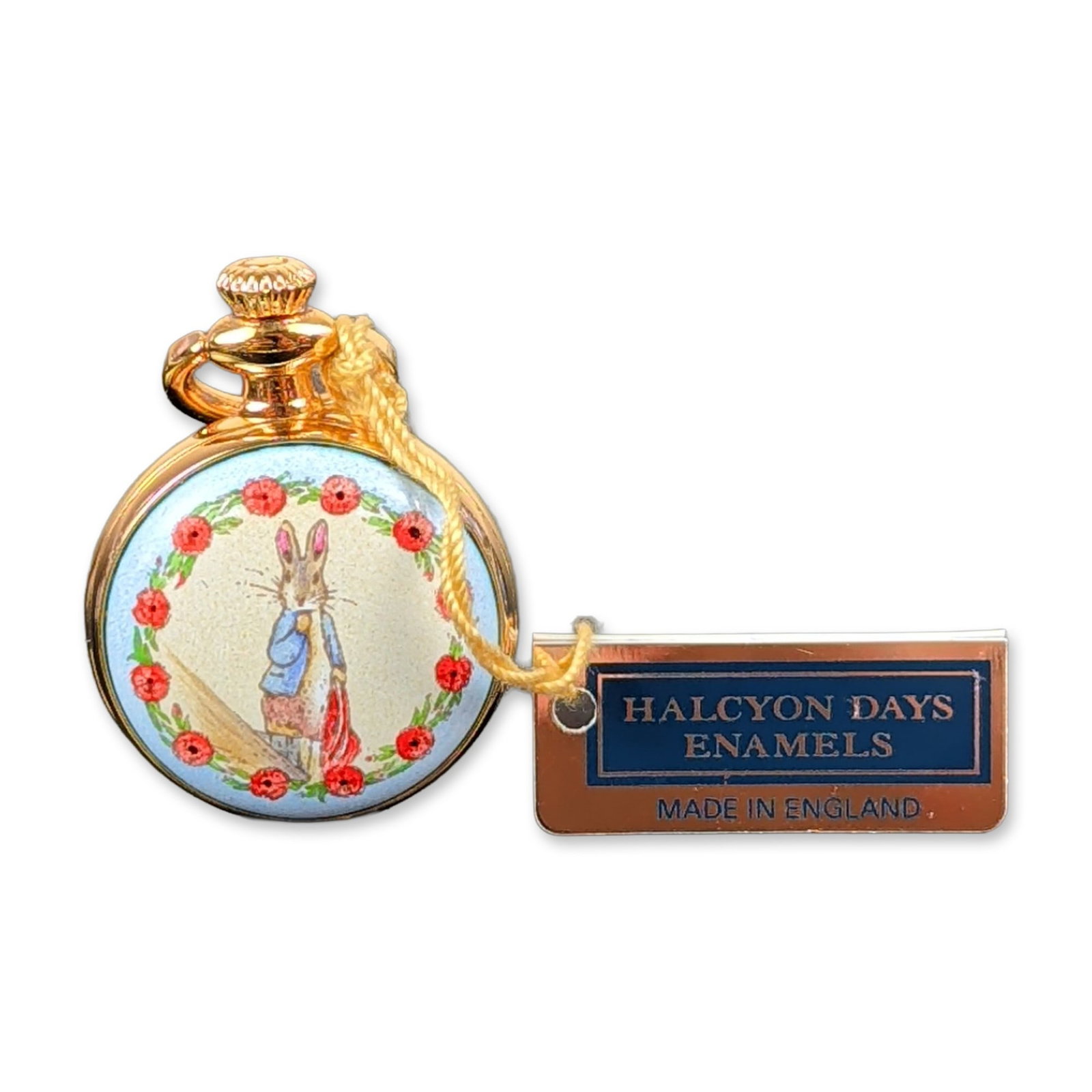 Halcyon Days Enamels Peter Rabbit Pocket Watch: This English miniature pocket watch by Halcyon Days Enamels features an enameled case back depicting Beatrix Potter's Peter Rabbit framed by a circular wreath of red rosebuds on a pale blue ground. Th