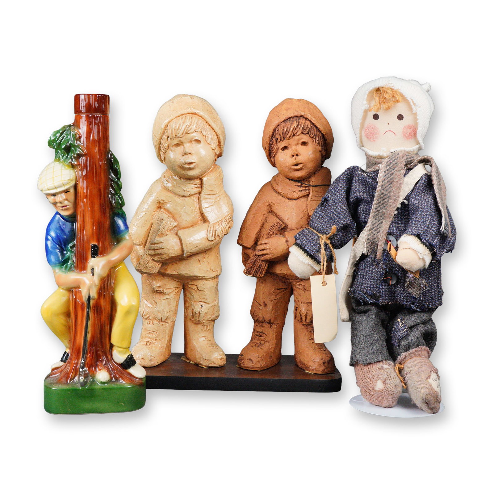 A Group of Decorative Objects, including a Pair of Lee Bortin Originals: A pair of textured, unglazed ceramic or resin statuettes by Lee Bortin Originals, depicting boys in winter clothing holding newspapers, displayed on a single wooden base. Also included is a glazed