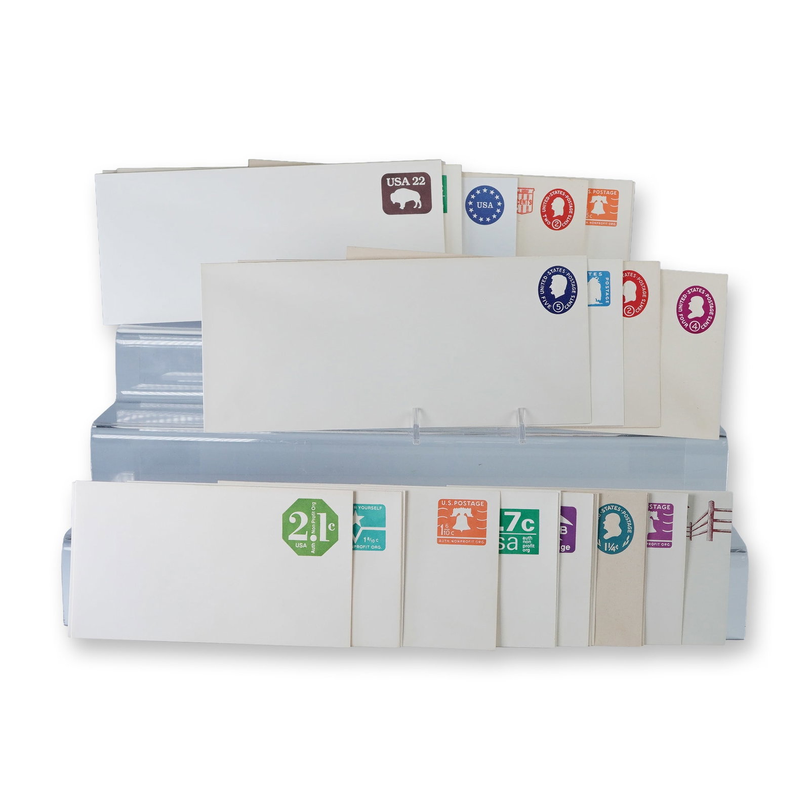 30pc Vintage US Postal Stationery Envelopes: Collection of thirty vintage United States postal stationery envelopes with pre-printed postage in assorted denominations and designs. Includes colorful examples featuring motifs such as the Liberty