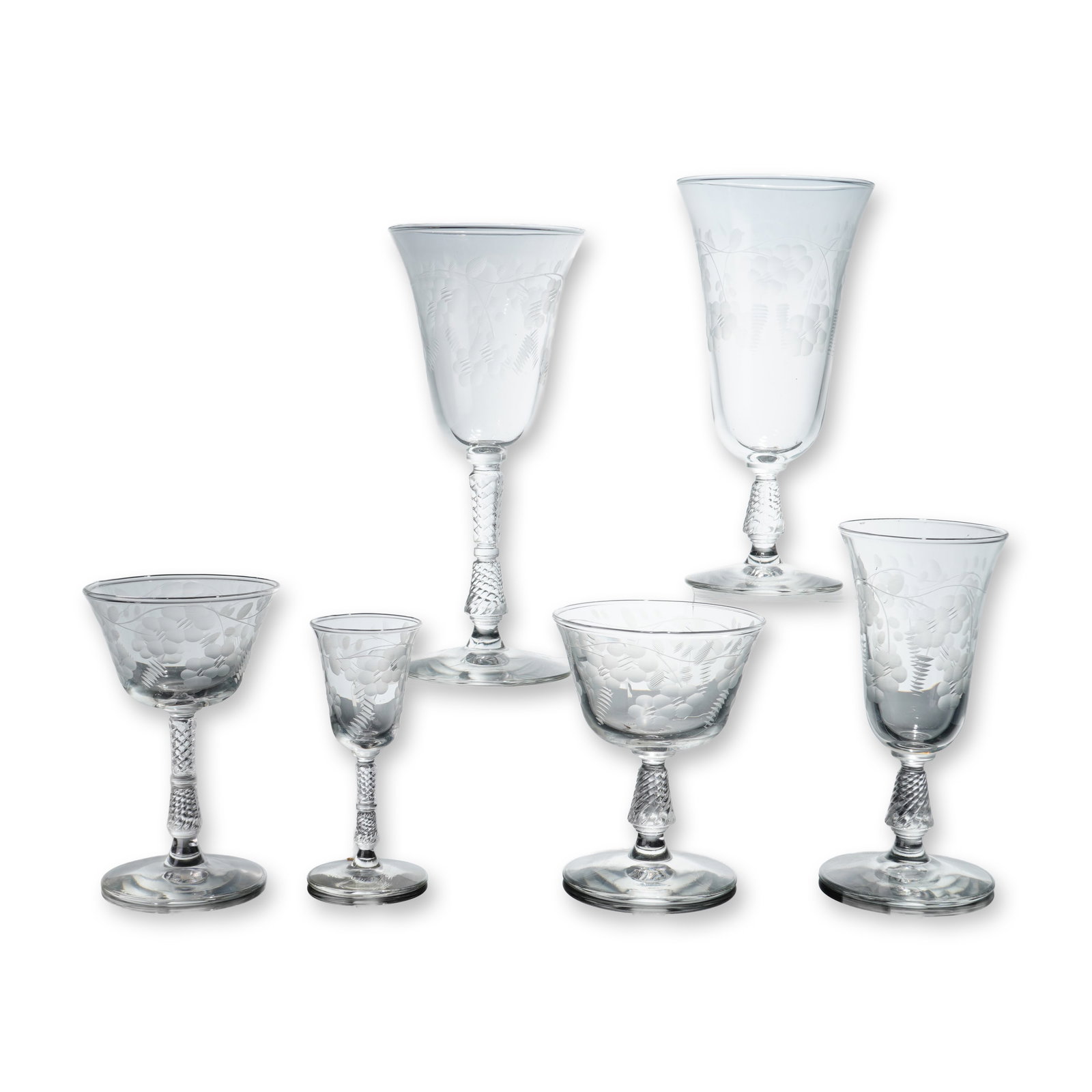 Set of Six Assorted Facet-Cut and Etched Glasses: A set of six clear lead crystal stemware pieces featuring wheel-engraved decoration and facet-cut stems. These etched glasses are decorated with a frosted motif of stylized vines, berry clusters, and 