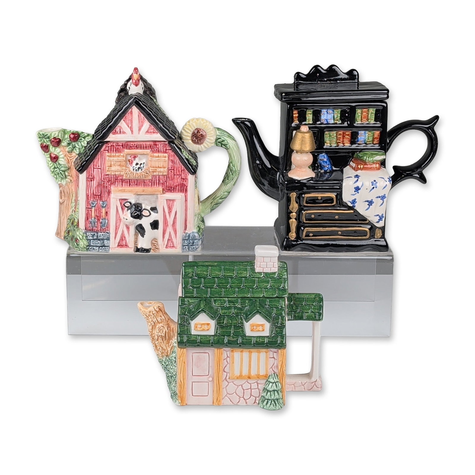 3pc Novelty Ceramic Architectural and Furniture Form Teapots: Wang's and other makers. Trio of novelty ceramic teapots in architectural and furniture forms. Includes a Chinese barn-form teapot with red exterior, rooster-form finial, cow figure at the stable