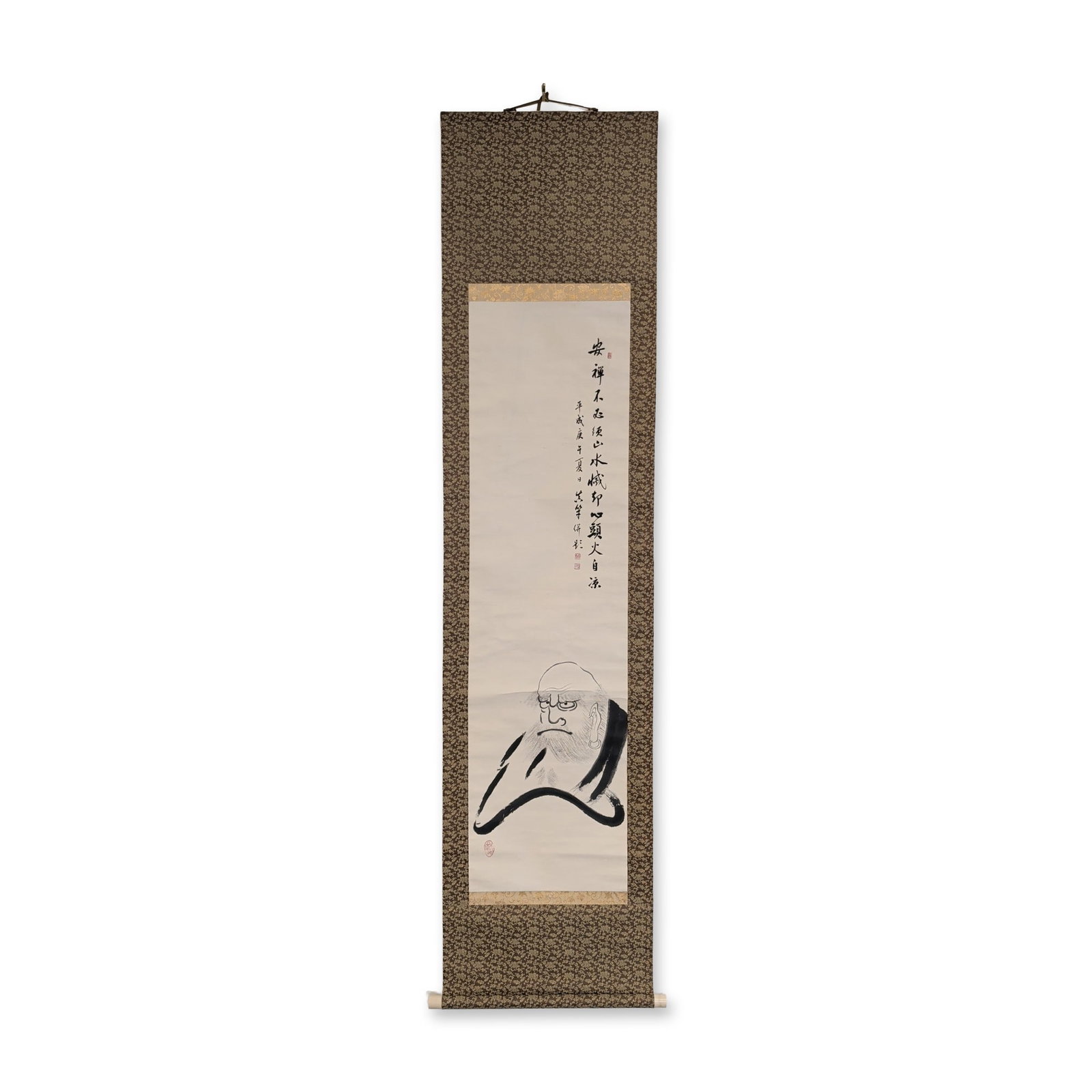 Japanese Seitetsu Daruma Ink and Washes on Paper Hanging Scroll, Signed w/ Seal: Japanese hanging scroll in ink on paper with decorative floral-patterned silk brocade mounting and rollers. The work depicts a minimalist zenga-style portrait of Daruma rendered in expressive ink wash