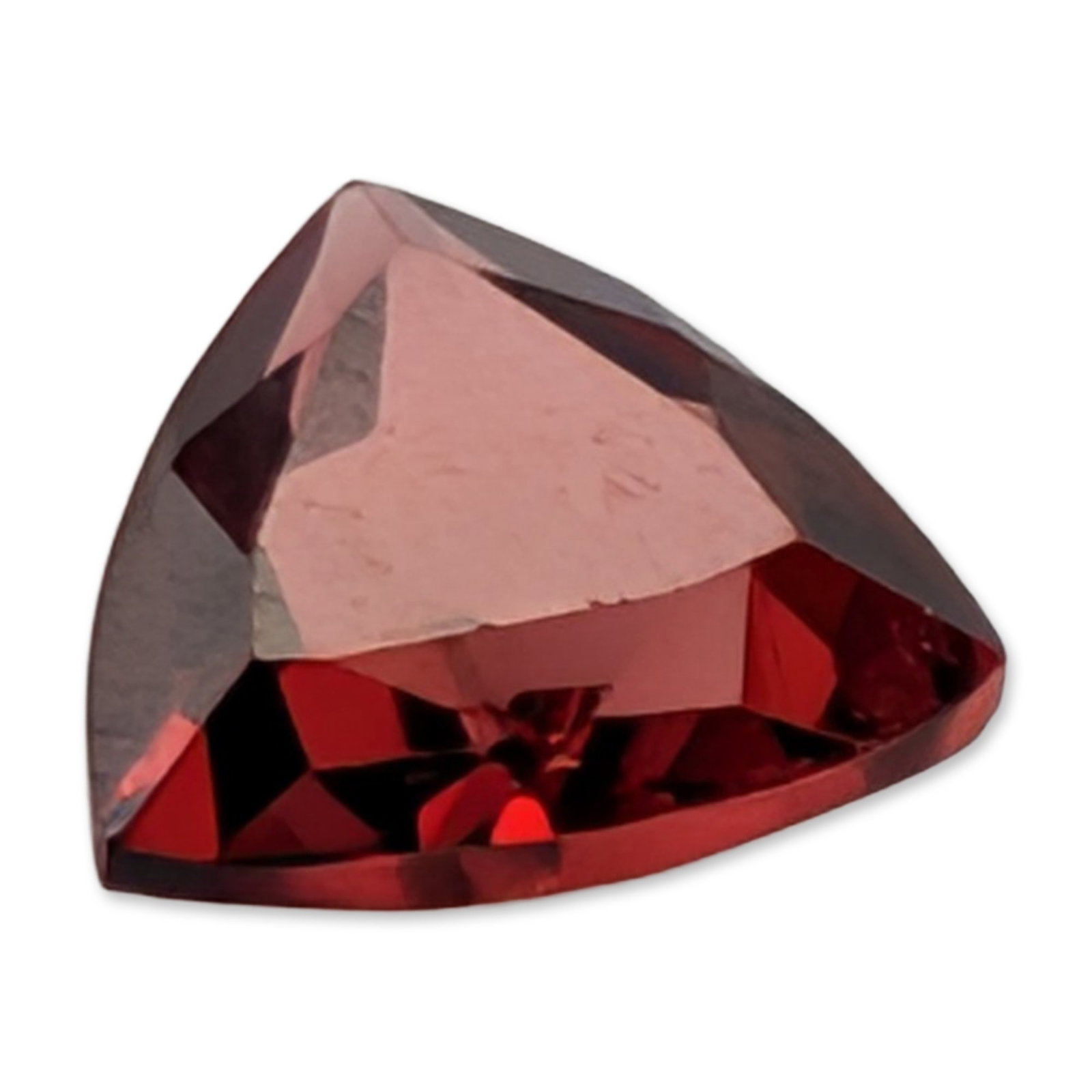 Loose Trillion Cut Red Garnet: Loose faceted garnet gemstone, featuring a trillion brilliant cut and deep reddish-pink to garnet red color. The stone exhibits transparency and facet definition. 0.9 ct. 6 mm. Dimensions: 6mm