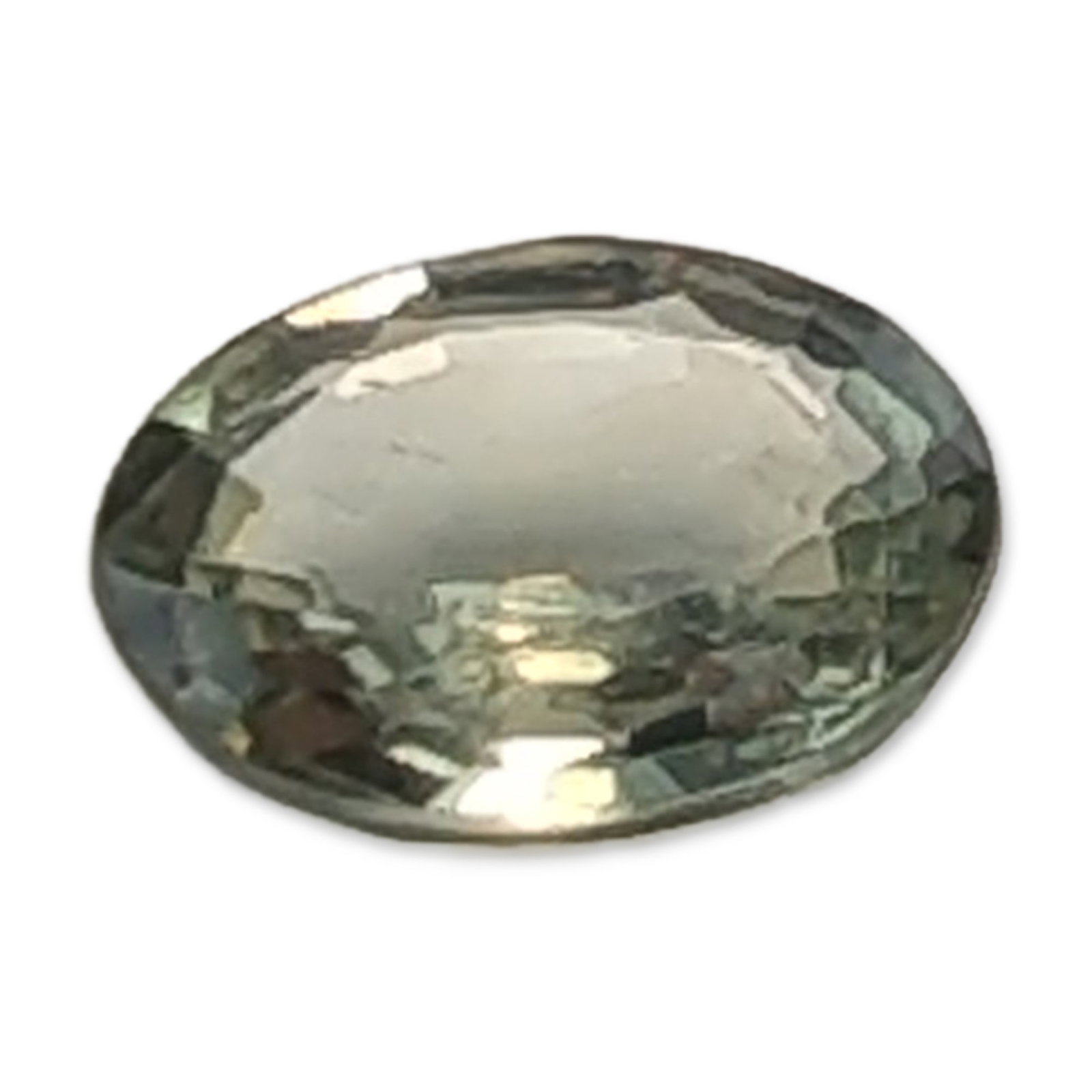 Oval Faceted Seafoam Green Sapphire Gemstone: Oval faceted Sapphire gemstone. The stone is a pale seafoam green color with visible internal inclusions and a slight window in the center of the cut. 5.0 mm 0.4 ct. Dimensions: 5.0mm