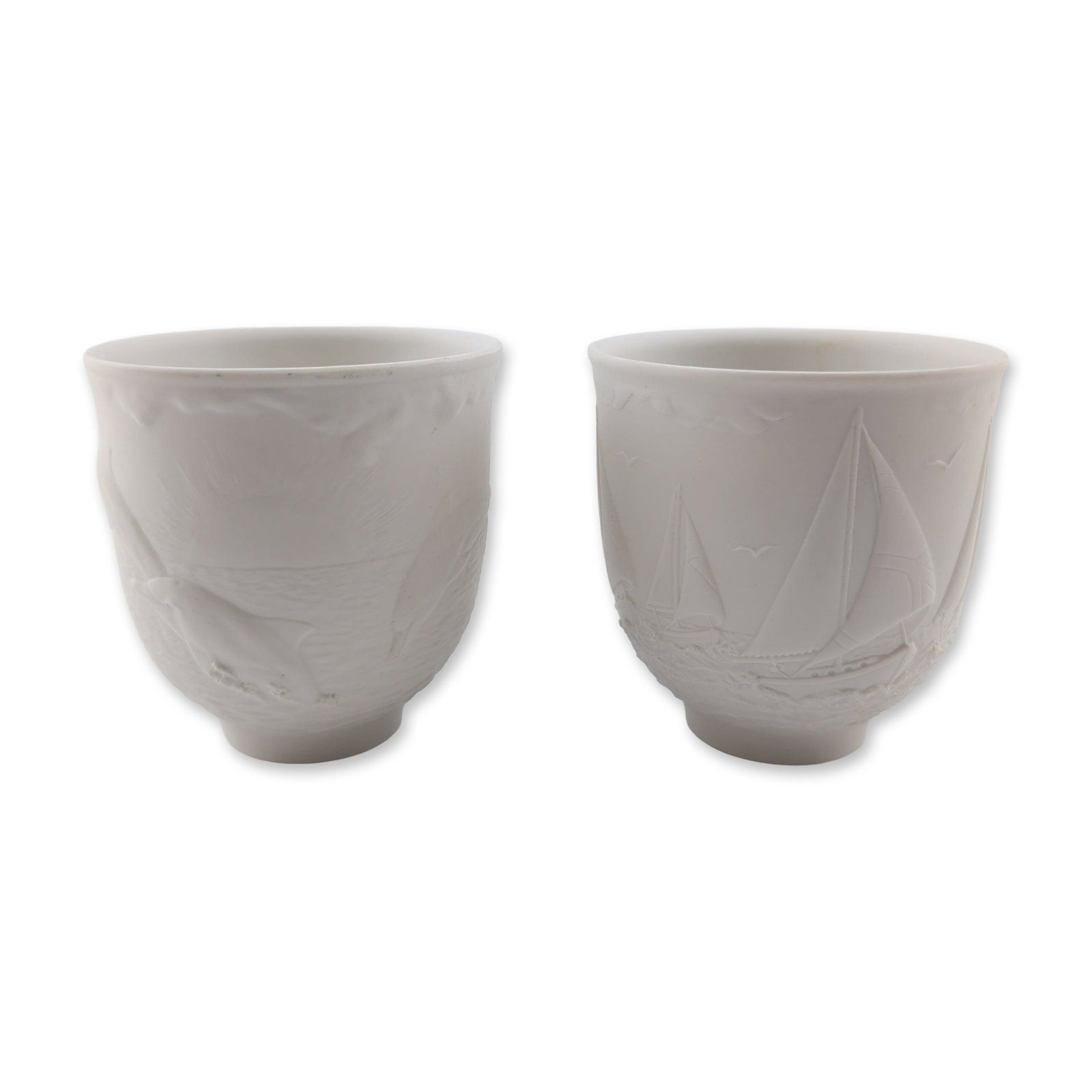Pair of Lladro Collectors Society Porcelain Votives 17657 and 17658: Lladro. Pair of matte white bisque porcelain votive candleholders from the Collectors Society series. Includes the 1997 annual piece titled Sailing the Seas (Portavela Regata) featuring a relief scene