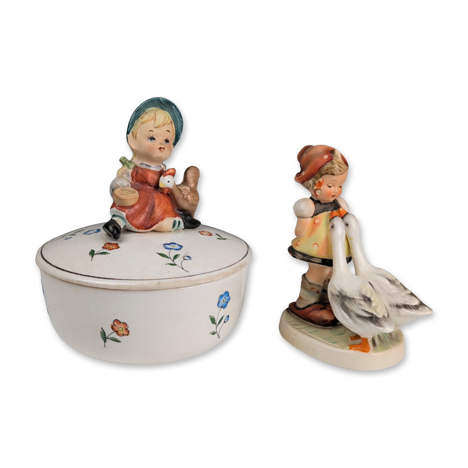 2pc Lipper & Mann Trinket Box and Goebel Hummel Figurine: The Goebel hand-painted figurine depicts a young girl standing beside two geese. Stamped in blue on the underside is a stylized large letter V with a small bee inside the open top, above the word Germ