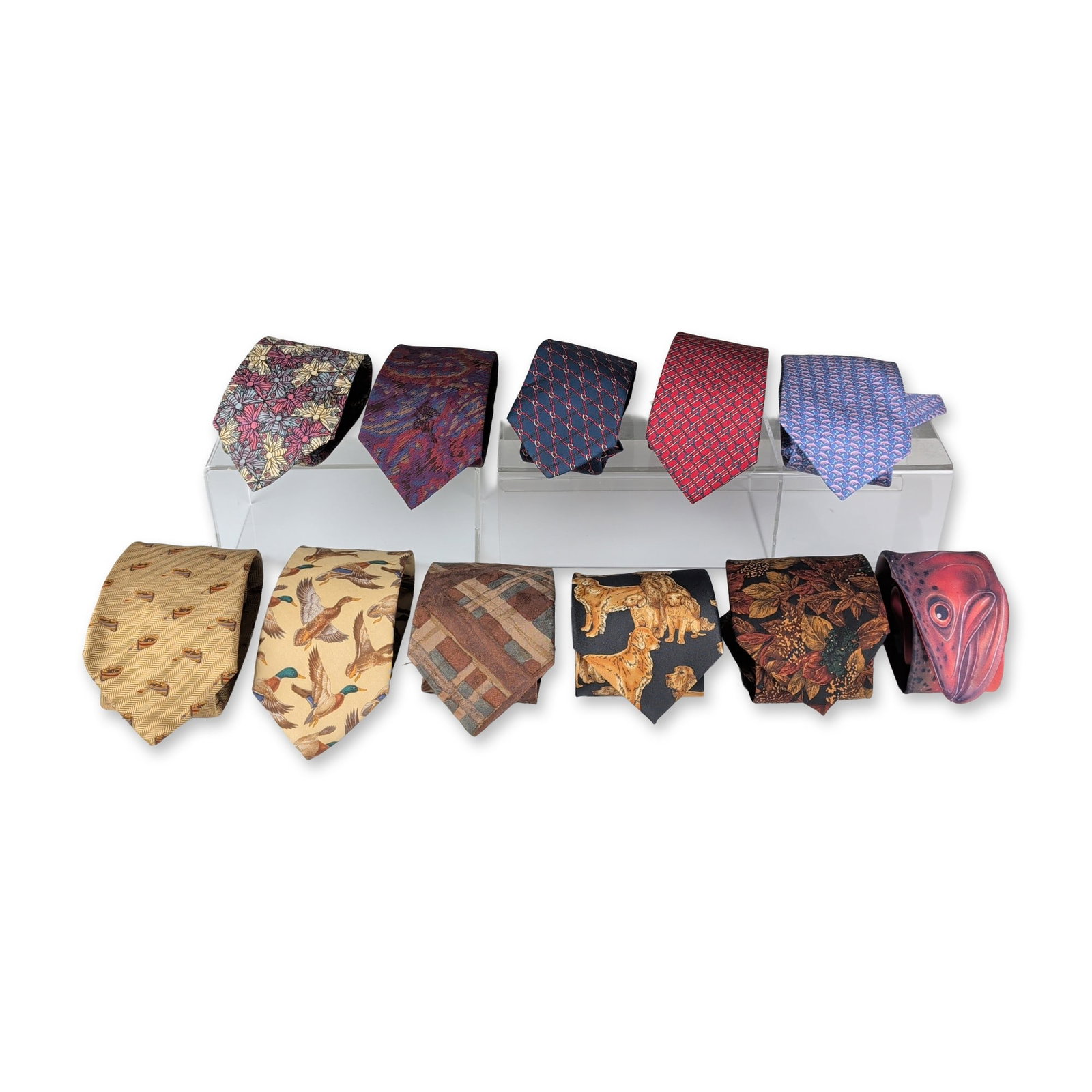 11pc Collection of Men's Designer and Novelty Neckties: Group of eleven men's neckties in various novelty, designer, and outdoor patterns. The collection includes silk and polyester examples with a diverse range of motifs, such as a butterfly tessellation,