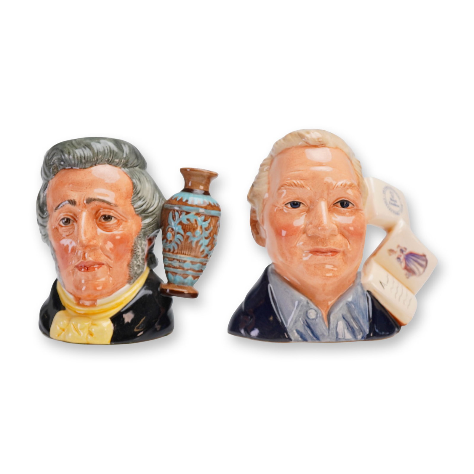 2pc Royal Doulton Small Character Jugs, D6703 and D7156: Royal Doulton porcelain character jugs produced for the International Collectors Club. The first small jug depicts Sir Henry Doulton (D6703), modeled by Eric Griffiths in 1982. This piece features a h