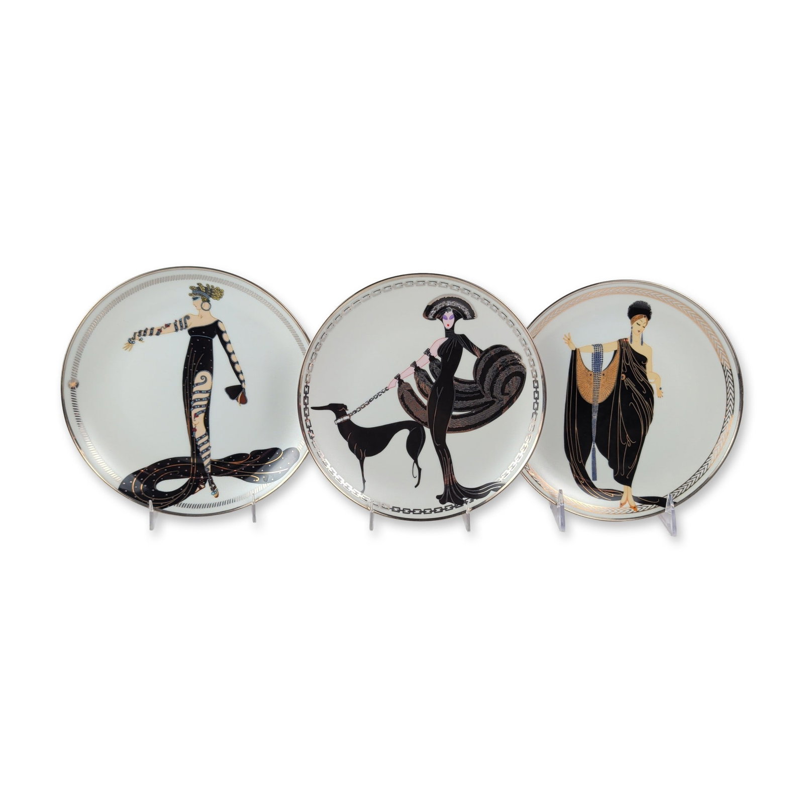3pc House of Erte Franklin Mint Porcelain Plates: Trio of House of Erte decorative porcelain plates produced by The Franklin Mint, 1993. Plates in fine porcelain featuring transfer-printed Art Deco fashion illustrations by Romain de Tirtoff (Erte) wi