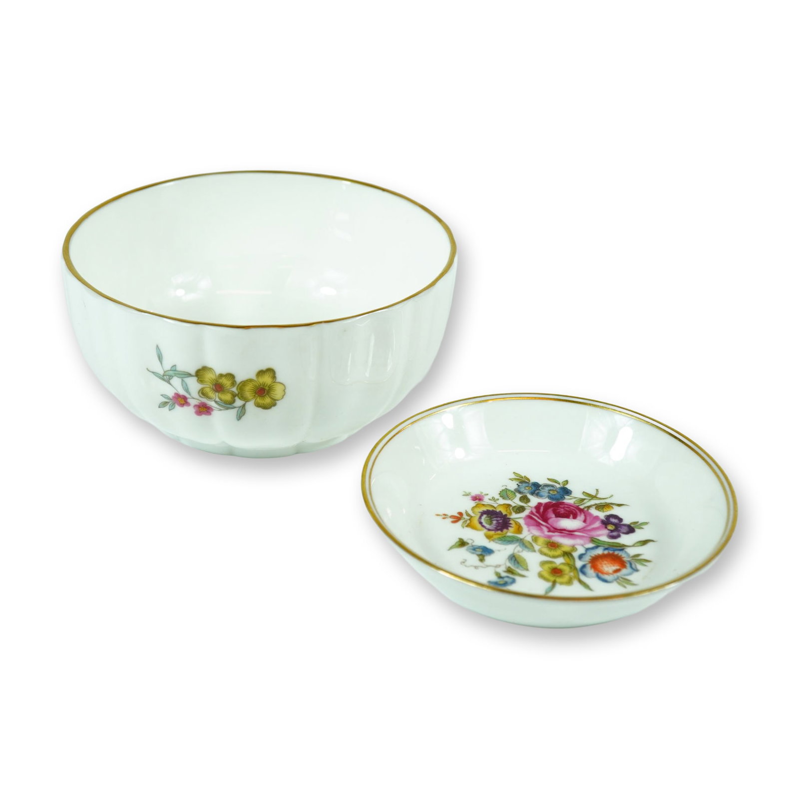 A Pair of Royal Worcester Floral Fine Bone China Bowl and Ring Dish: This pair of fine bone china items consists of a small fluted bowl and a matching ring dish manufactured by Royal Worcester. The pieces feature a lobed and fluted form decorated with polychrome