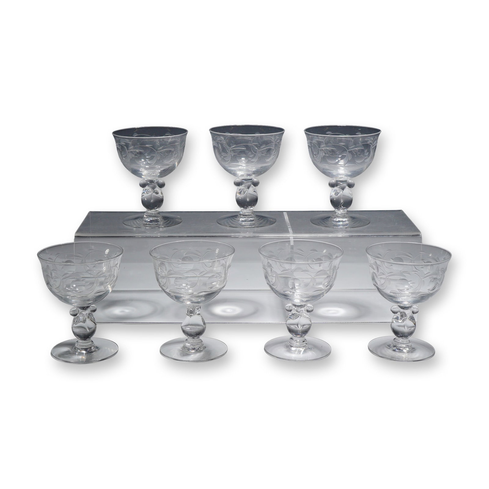 Set of Seven Heisey Southwind Pattern Crystal Sherbet Glasses: This set of seven glasses is attributed to Heisey, featuring the Southwind wheel-etched pattern (etching number 1030) on the Barcelona stem (stem number 1506). The collection consists of seven matchin