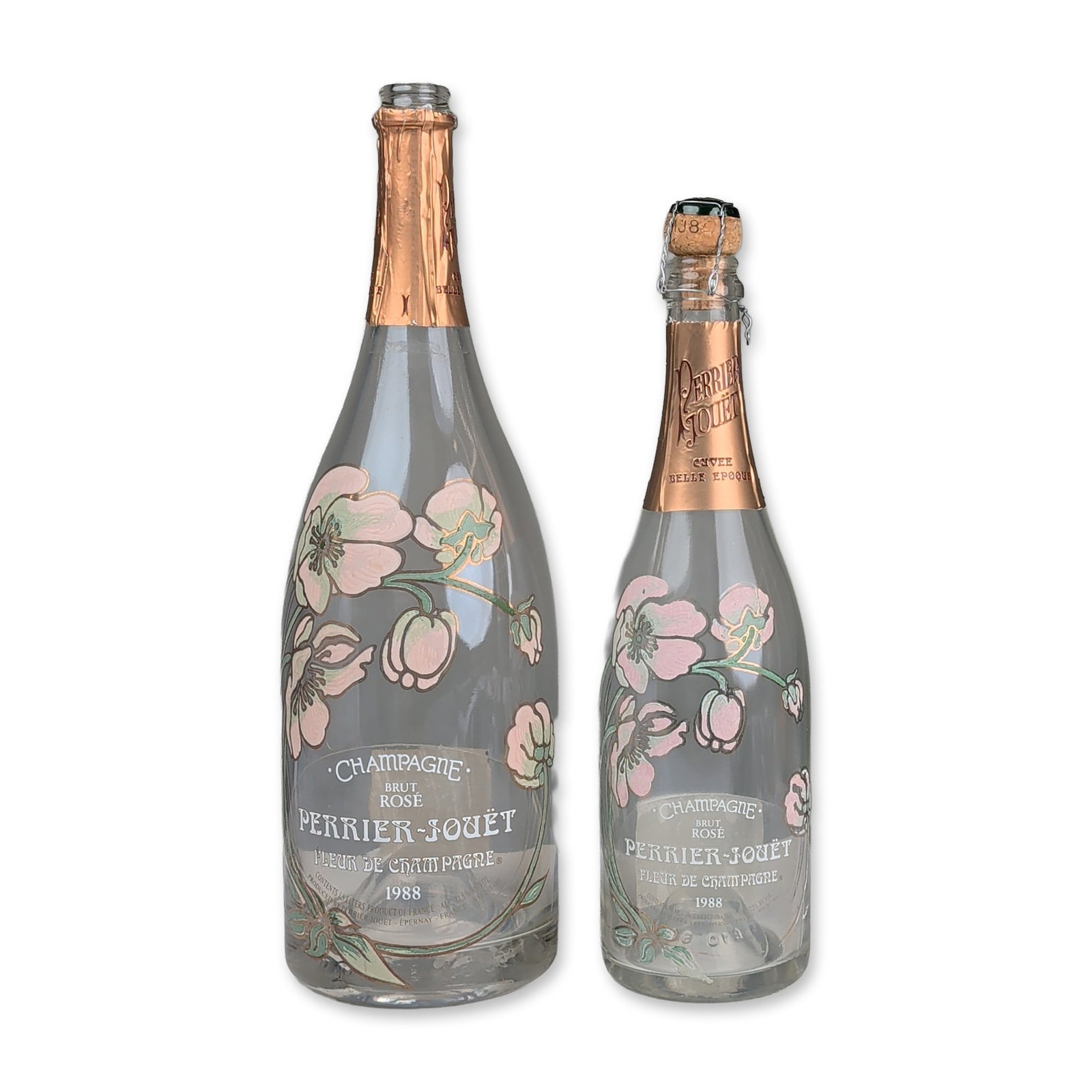 2pc 1988 Perrier-Jouet Fleur de Champagne Brut Rose Bottles: Perrier-Jouet, Champagne, France empty 1988 vintage Fleur de Champagne (Belle Epoque) Brut Rose 750ml bottles. Clear glass construction featuring enameled Art Nouveau anemone decoration in pink,