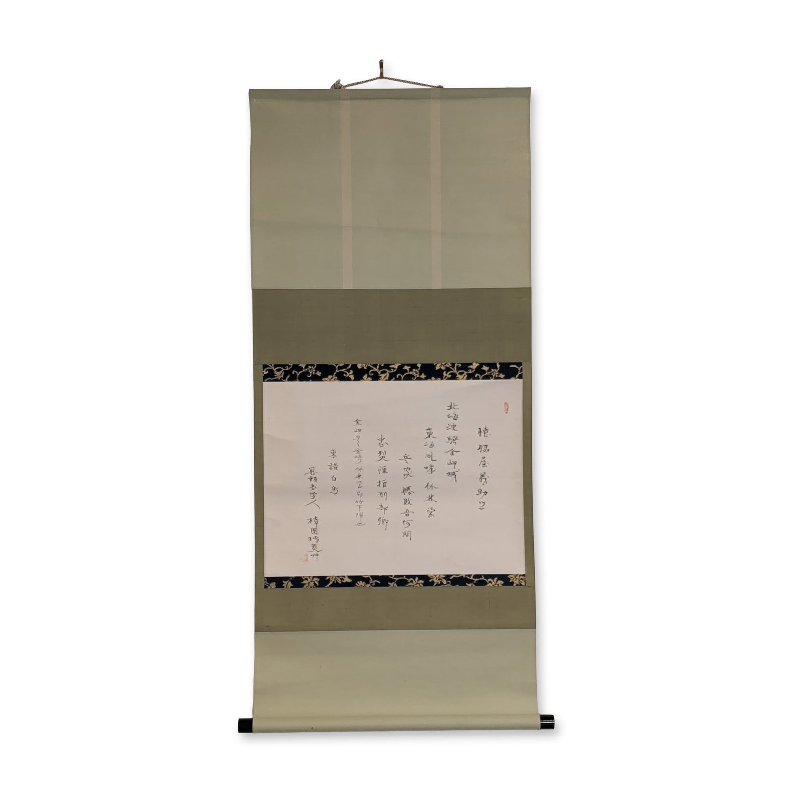 Japanese Ink on Paper Calligraphy Hanging Scroll: Japanese calligraphy handscroll in ink on paper, featuring a poem to a samurai warrior. The work is mounted on sage green fabric with navy blue silk brocade borders decorated in a gold floral vine pat