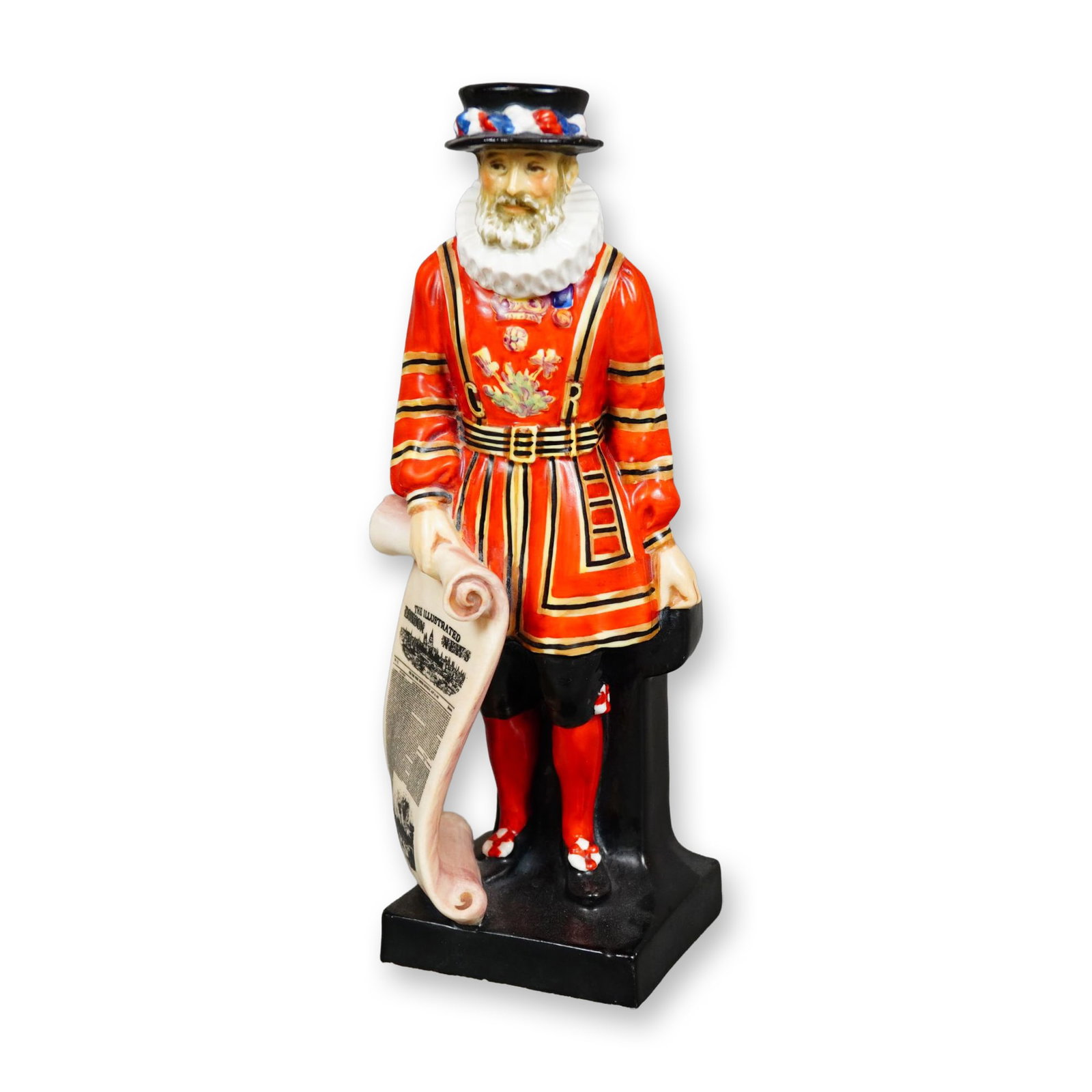 Royal Doulton Porcelain Figurine, Beefeater: Hand painted figure of a standing Beefeater holding a long scroll of "The Illustrated London News". Underside is marked Royal Doulton. Dimensions: 3"L x 2.75"W x 7.75"H Manufacturer or Brand: Royal Do