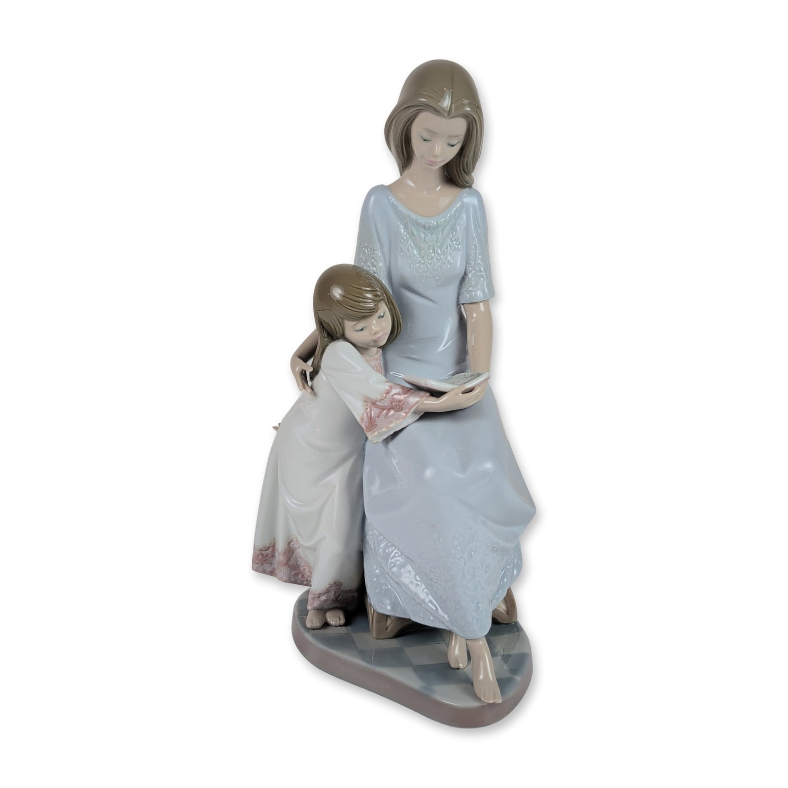 Lladro Bedtime Story Porcelain Figurine 5457: Spanish Lladro glazed porcelain figurine titled Bedtime Story, model number 5457. The sculpture depicts a woman in a pale blue gown seated on a tufted-back chair reading from an open book to a young g