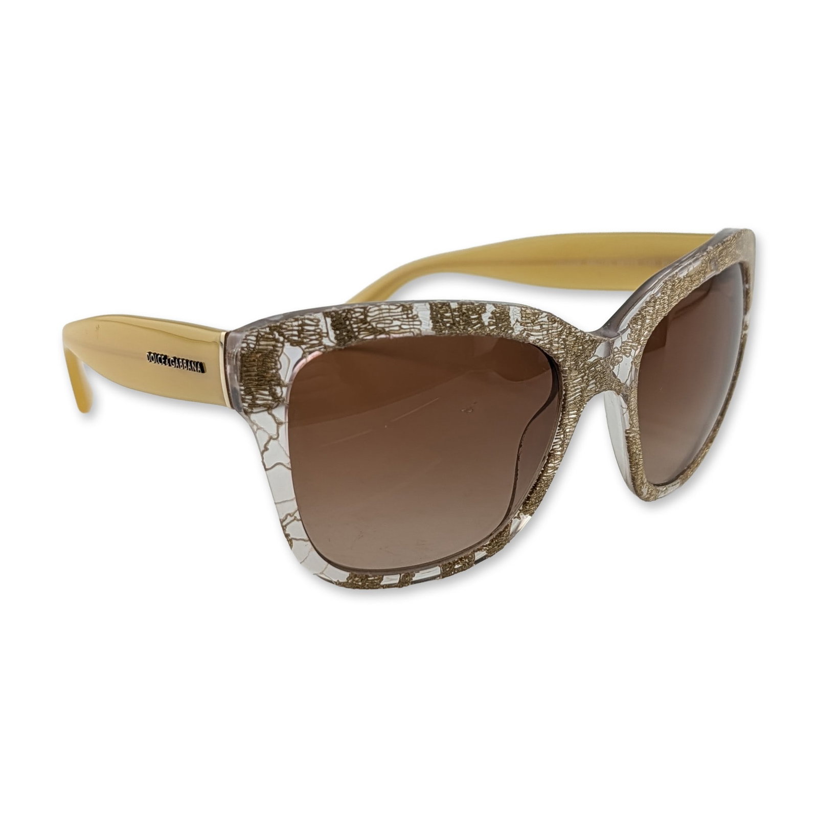 Dolce & Gabbana Gold Lace DG 4226 Sunglasses: Dolce & Gabbana women's sunglasses, model DG 4226, featuring clear acetate frames with an integrated gold-tone metallic lace inlay and contrasting pale yellow opaque acetate temples. The modified cat-