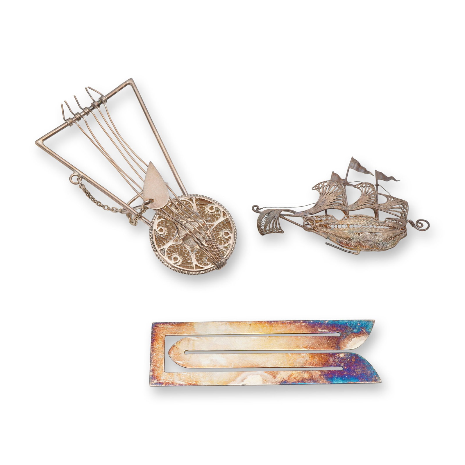 3pc Sterling Silver Items Including Robbe & Berking Bookmark: This lot contains three decorative sterling silver items consisting of a sterling silver bookmark, a filigree sailing ship brooch marked 925, and a miniature filigree stringed instrument (tested sterl