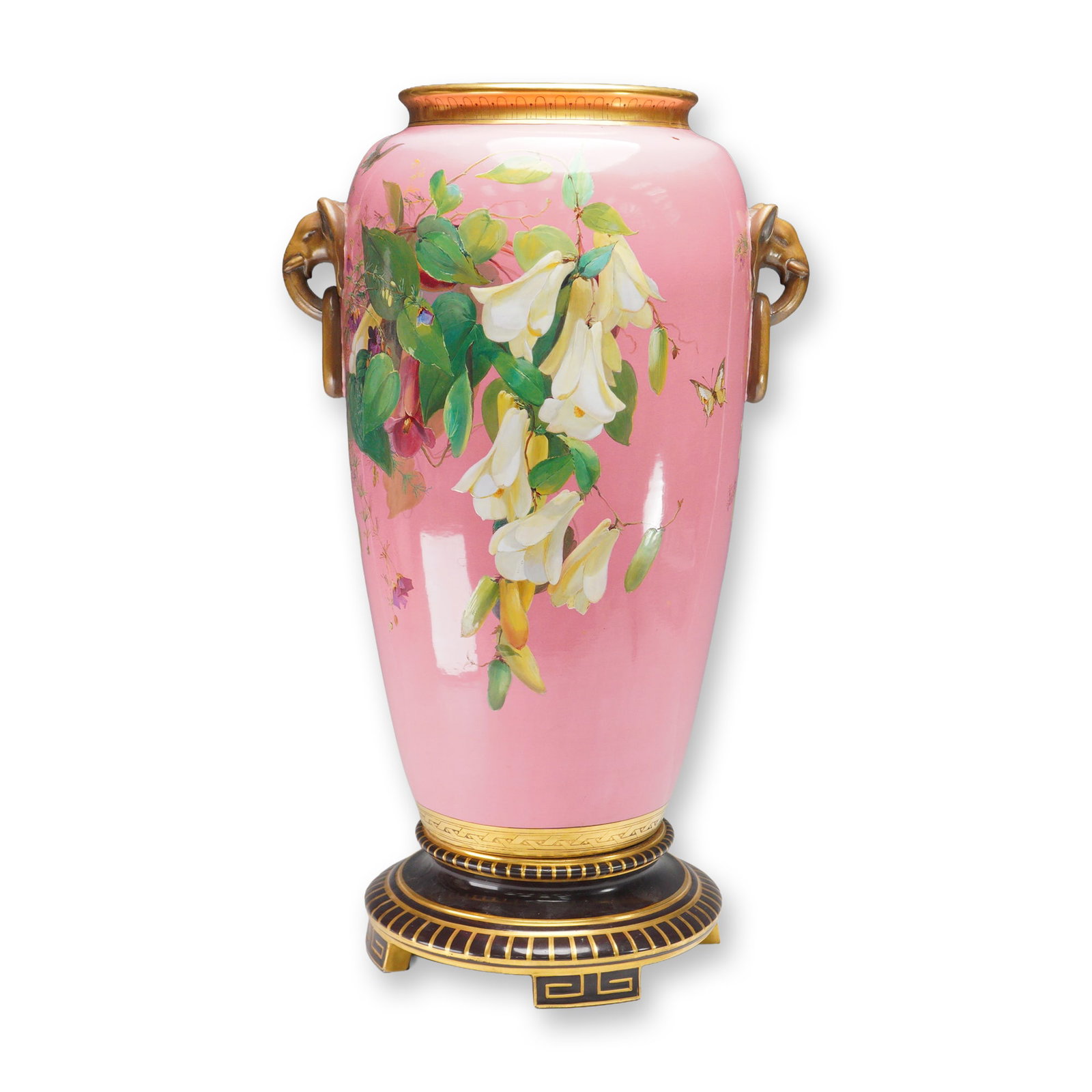 Large Minton Porcelain by Richard Pilsbury Vase: Striking, large porcelain vessel richly painted on both sides with flowers and butterflies against a pink ground. This piece is further embellished with gilt elephant head handles and a black and gilt