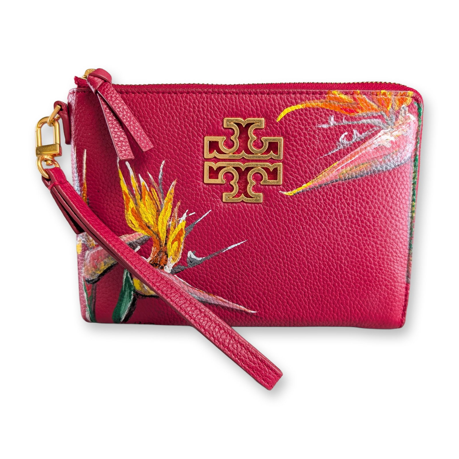 Tory Burch Redstone Leather Britten Large Zip Pouch w/ Hand Painted Birds of Paradise: Tory Burch Britten large zip pouch in redstone pebbled leather, featuring a hand-painted bird of paradise floral motif in yellow, orange, and green. The front is accented with a large gold-tone metal 