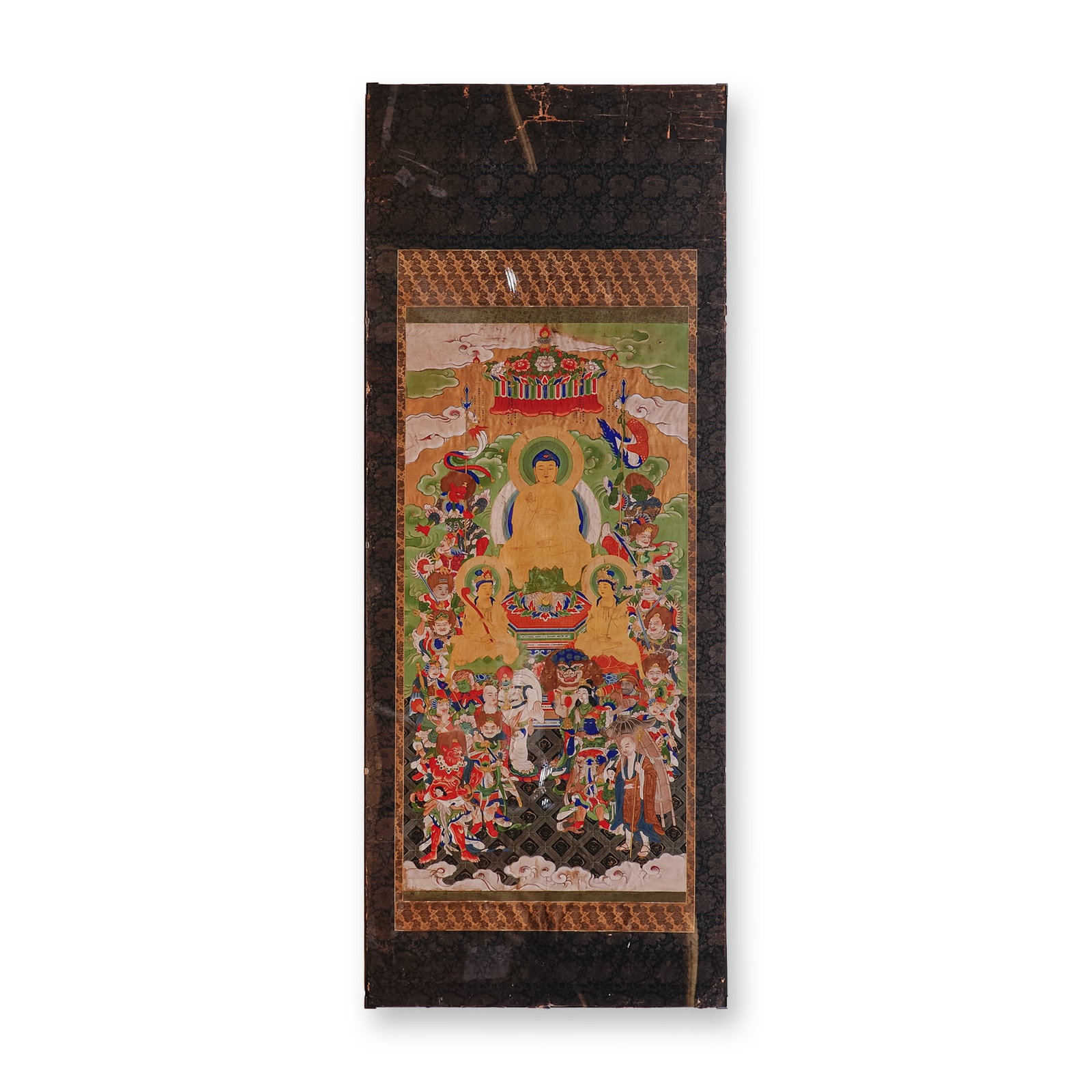 19th Century Tibetan Thangka Depicting Buddha, Tempera on Silk & Cotton: A magnificent 19th century Tibetan thangka, hand painted in tempera on silk and cotton, depicting a central image of Buddha seated in serene meditation with his right hand raised in the gesture of rea