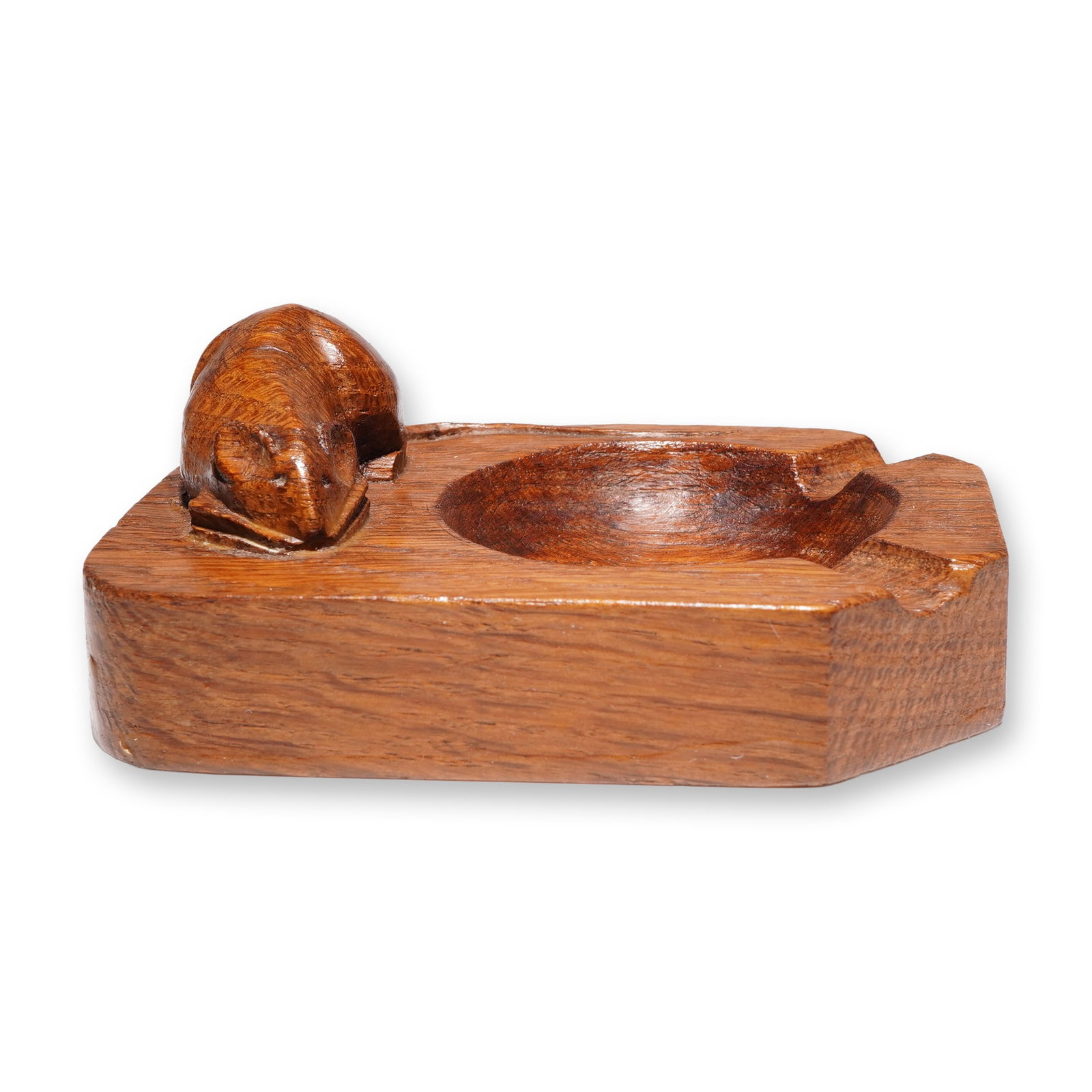 Robert 'Mouseman' Thompson Oak Ashtray: Robert "Mouseman" Thompson (1876-1955), also known as 'Mousey' Thompson, was a British furniture maker based in Kilburn, Yorkshire, England. He established a workshop specializing in oak furniture, di