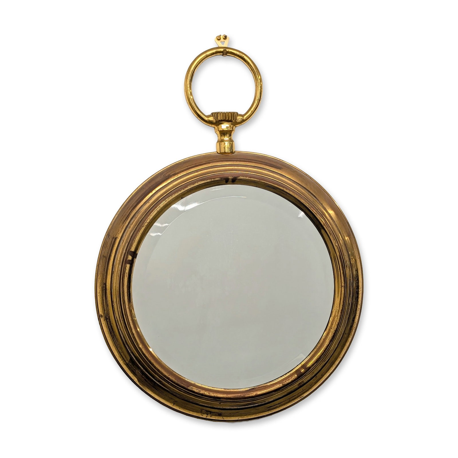 Spanish Brass Pocket Watch Style Convex Mirror: Spanish decorative wall mirror designed in the form of an oversized pocket watch. The frame is constructed from brass-toned metal featuring a decorative winding crown and a large bow ring for suspensi