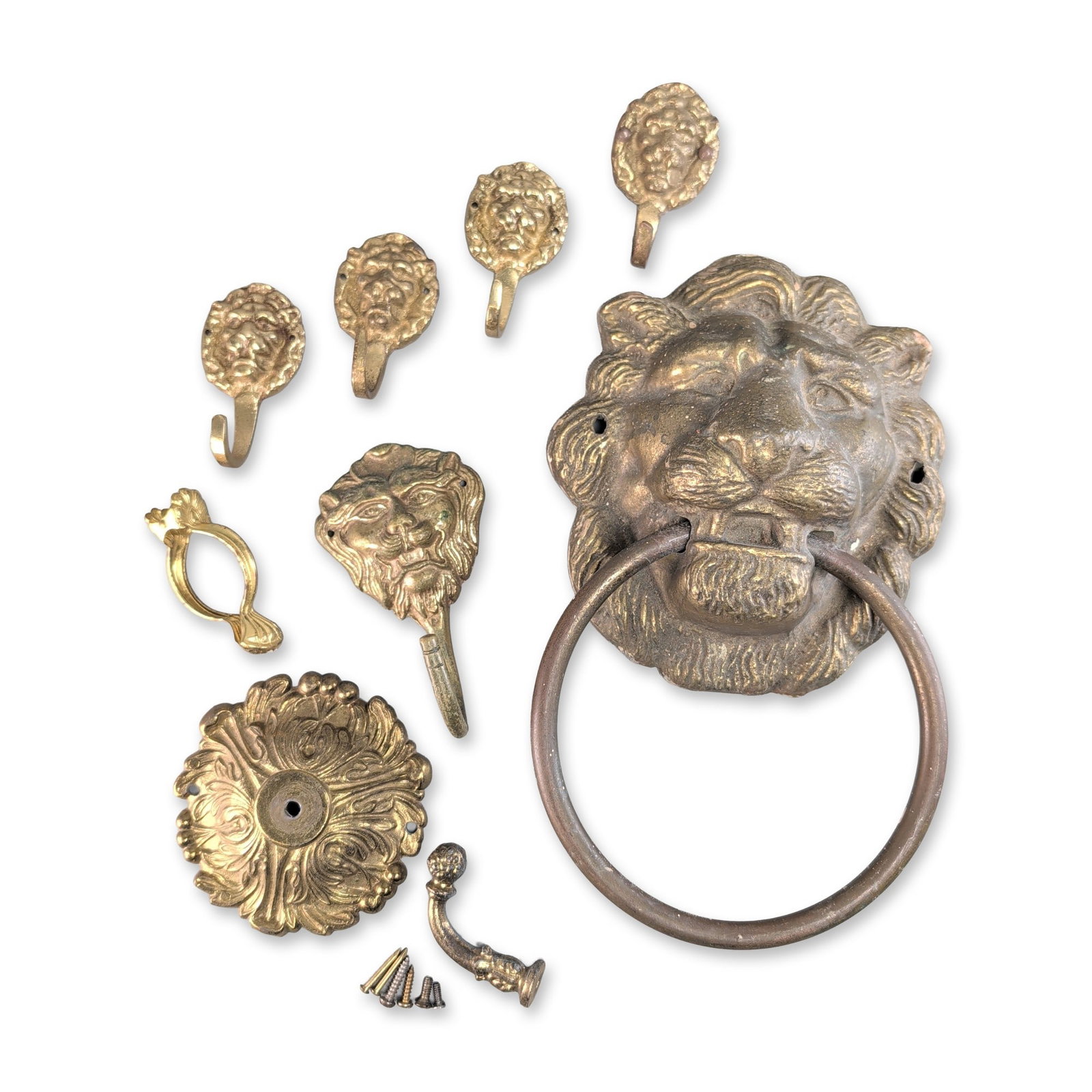 9pc Cast Brass Lion Motif Door Knocker and Hooks: Neoclassical style assortment of nine cast brass furniture and architectural hardware featuring lion head motifs. The group includes a large lion head door knocker with a heavy ring, a medium lion hea