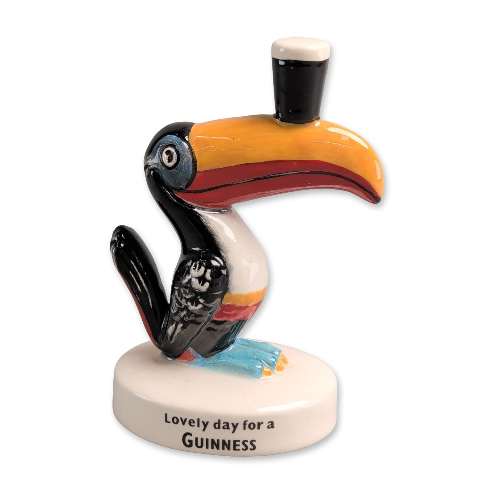 Royal Doulton Guinness Toucan Advertising Figurine, Lovely Day For A Guinness AC8: Limited edition, 55 out of 2000, advertising figurine featuring the mascot Toucan for Guinness brewery. The hand-decorated bone china figure depicts a stylized toucan with a black top hat perched on i