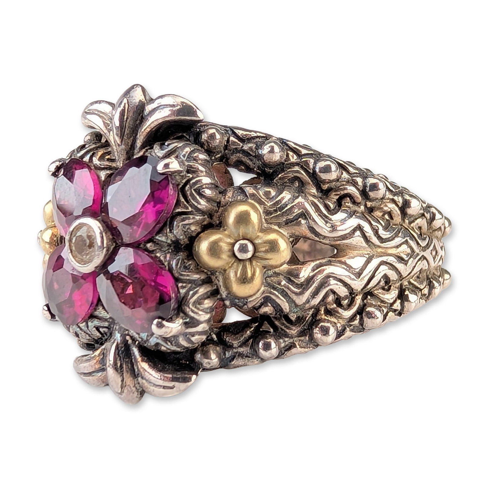 Barbara Bixby Sterling Silver and 18K Gold Garnet Ring: Barbara Bixby floral statement ring in sterling silver and 18k yellow gold, featuring a central flower composed of four oval-cut rhodolite garnets surrounding a small round bezel-set white topaz stone