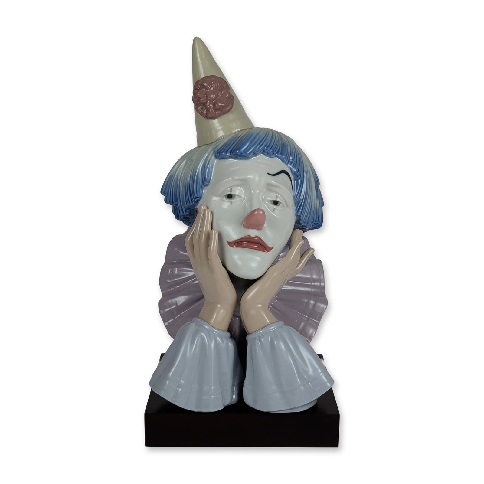 Lladro Spanish Porcelain Jester Bust 5129: Lladro Spanish porcelain bust of a sad clown, titled Jester designed by Jose Puche. The figure is depicted with a melancholic expression, chin resting on both hands, wearing a tall conical cream-color